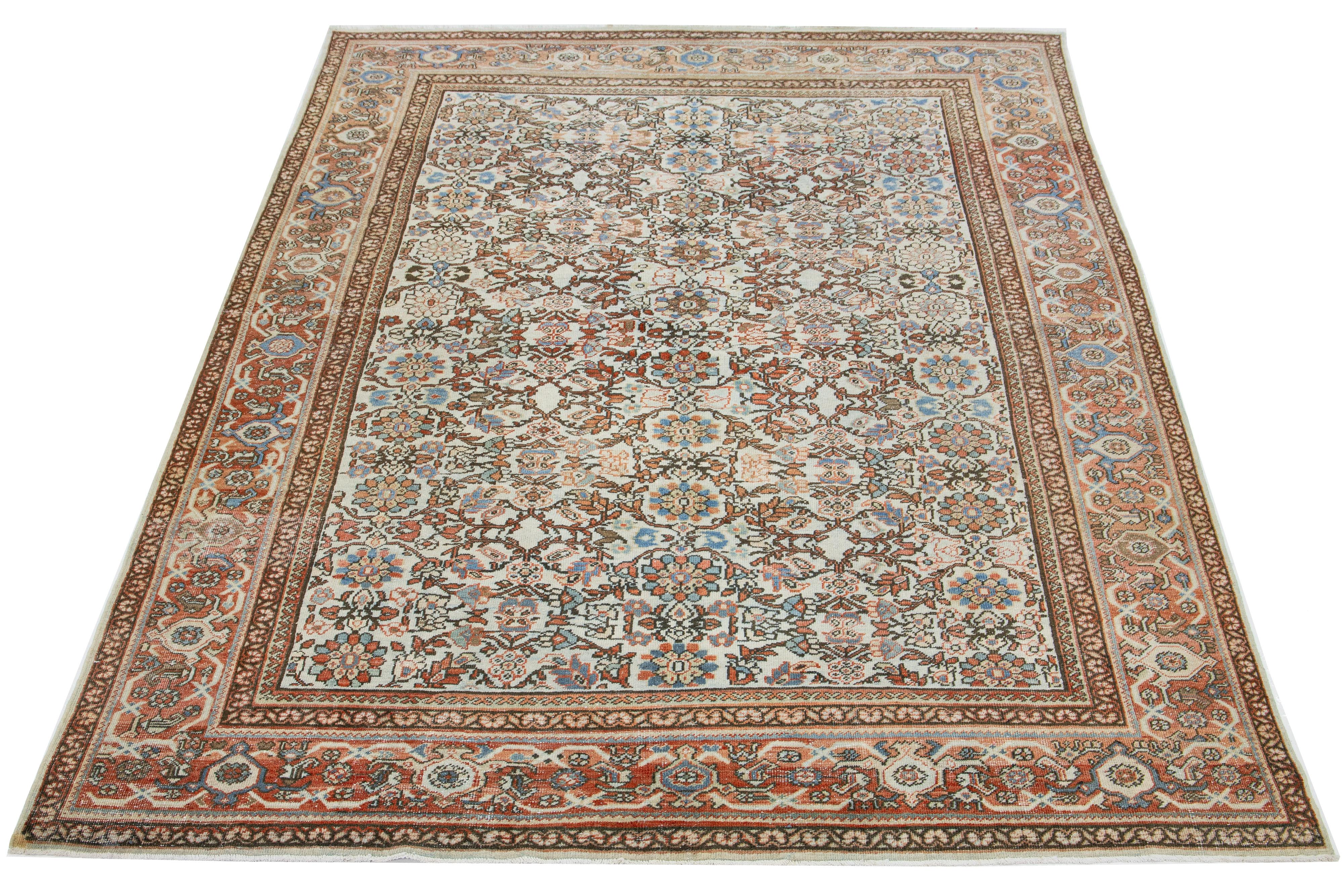 This vintage Persian Mahal wool rug features a beige background and multicolored floral designs.

This rug measures 8'11