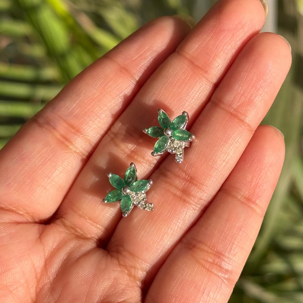 Natural Emerald Diamond Floral Stud Earrings in sterling silver to make a statement with your look. You shall need stud earrings to make a statement with your look. These earrings create a sparkling, luxurious look featuring oval cut natural emerald