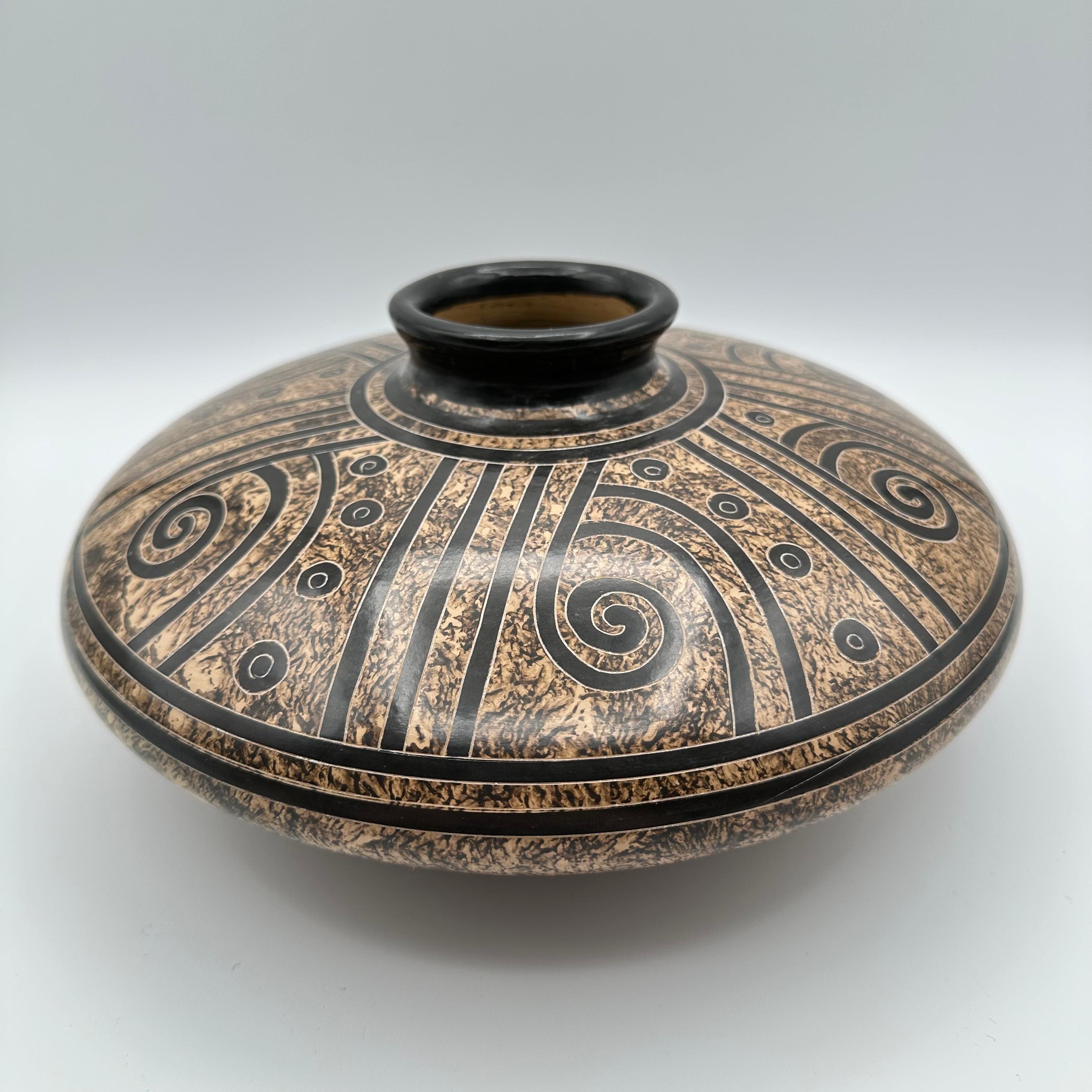 Handmade ceramic pottery vase in brown, beige, taupe, sand and other earth tones with geometric, spiraling motif. Contrasting dark and light glazes enhance the design. Made in the town of San Juan de Oriente in Nicaragua, famous as the home of an
