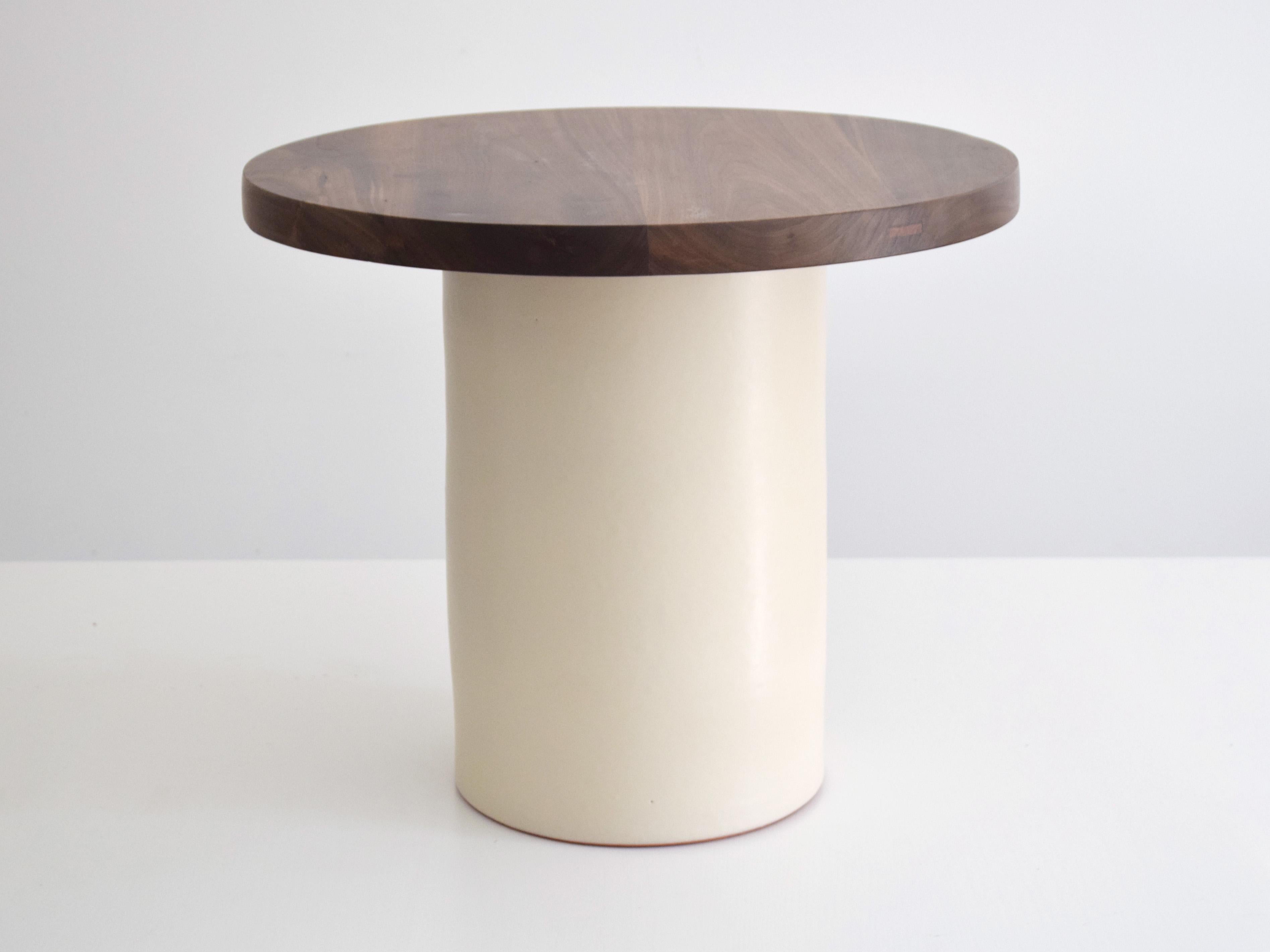This handcrafted coffee table combines a sculptural ceramic base with a solid walnut top, balancing artisanal craftsmanship with modern design. Designed for use as a side table or compact coffee table, it works beautifully in contemporary interiors