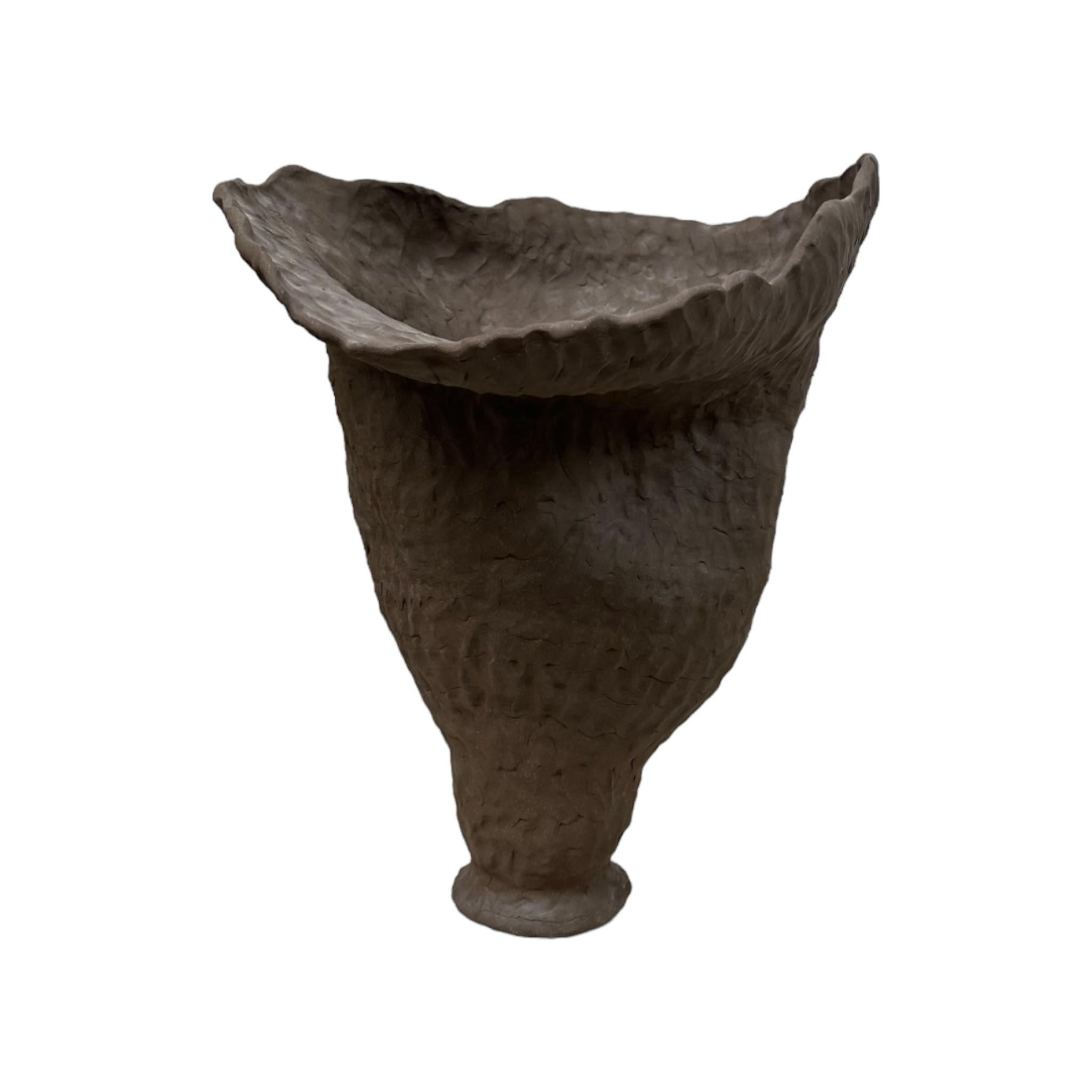 This Handmade Organic Ceramic Vessel captures the raw beauty of nature in its form and texture. The piece features an earthy, irregular surface that evokes the natural feel of weathered stone or clay. Perfect as a decorative sculpture, this unique