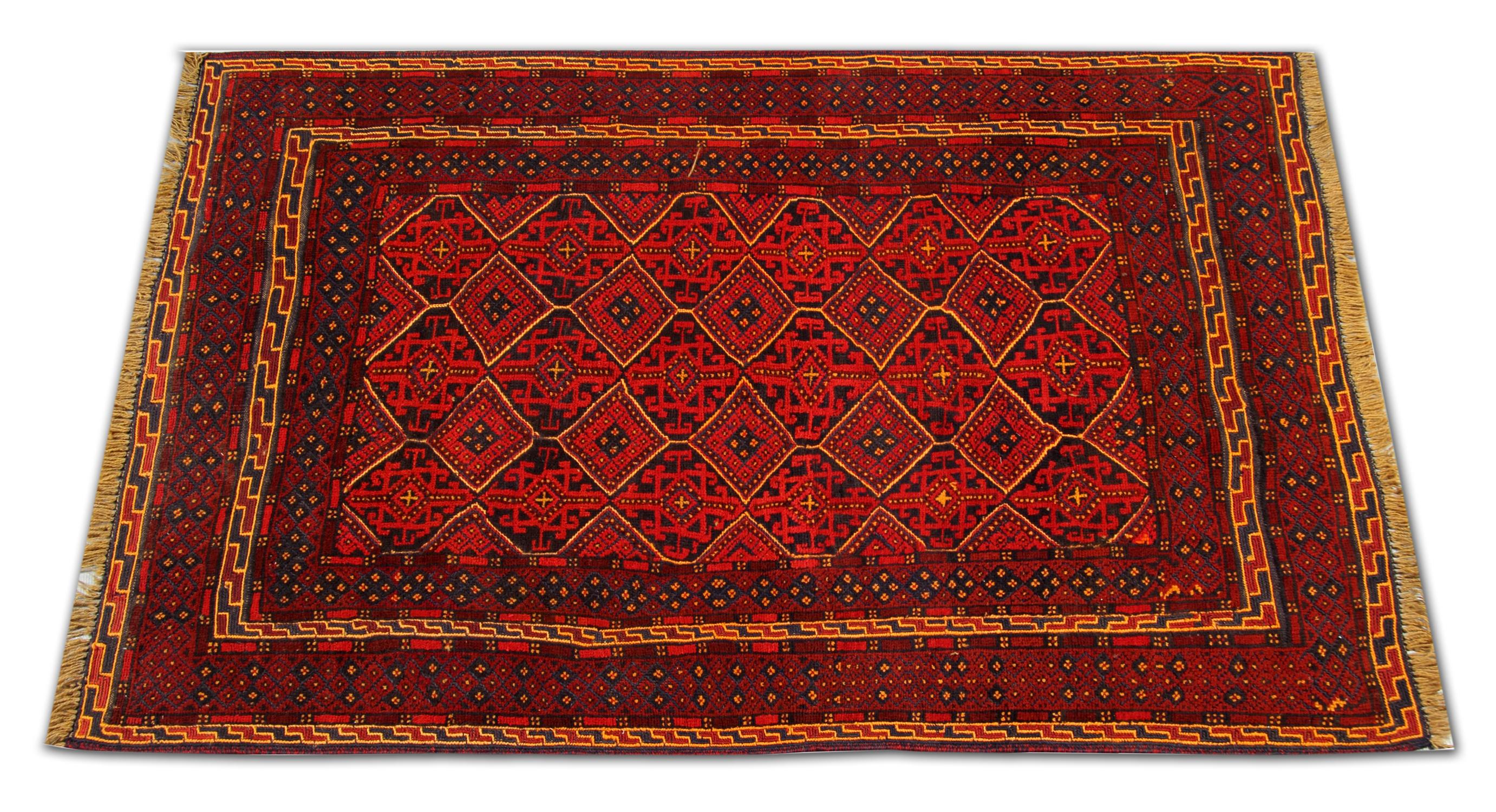 This red wool rug is an example of a fine Afghan rug made by highly skilled Turkmen weavers, known for their exquisite handmade rugs, in the north of Afghanistan. They have used hand-spun wool and 100% organic dyes for the production of these wool