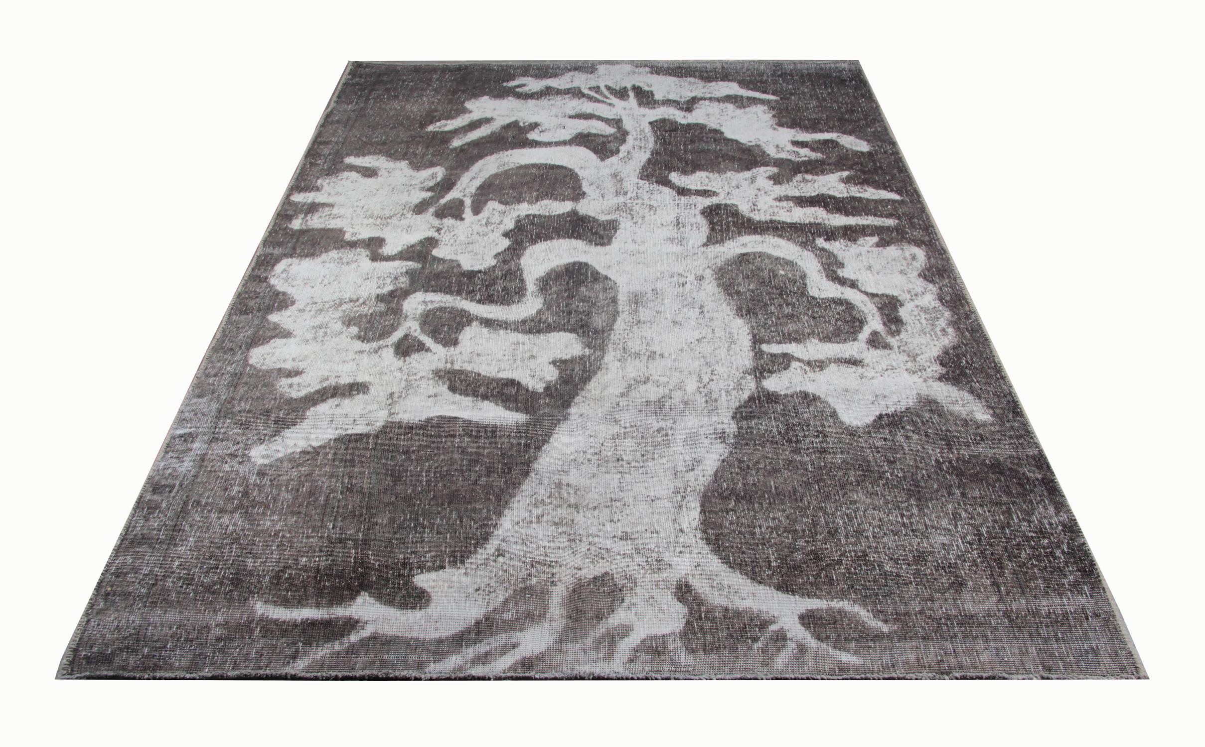 This oriental Turkish carpet is a handmade oriental rug coloured in different shades of black, white and grey. This traditional rug would be suited as a wall rug or placed on a wall as a home furnishing. This floral pattern is handmade using