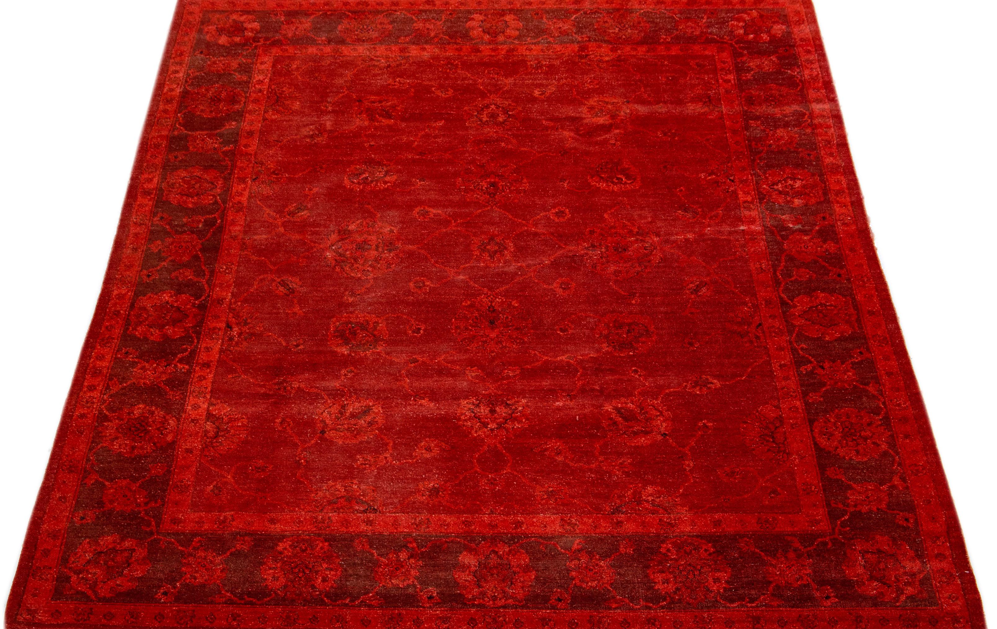 Presented in the overdye Art & Crafts style, this wool rug exhibits timeless elegance with a tasteful blend of delicate floral patterns and a vivid red background.

This rug measures 7'10