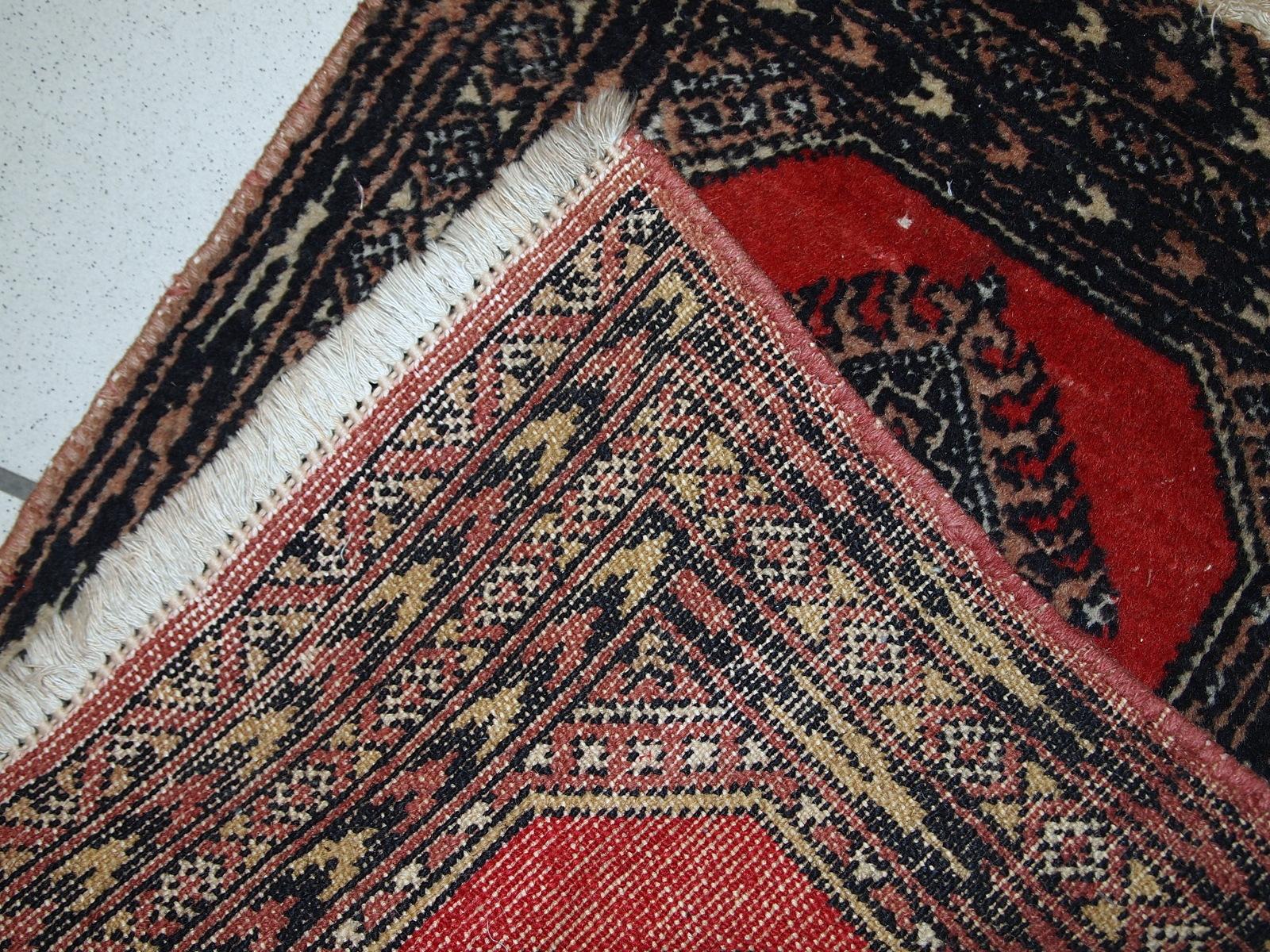 Vintage rug from Pakistan in distressed condition. The rug made in the end of 20th century in red wool.

-condition: distressed,

-circa: 1970s,

-size: 1.4' x 1.9' (45cm x 58cm),

-material: wool,

-country of origin: Pakistan,

-style: