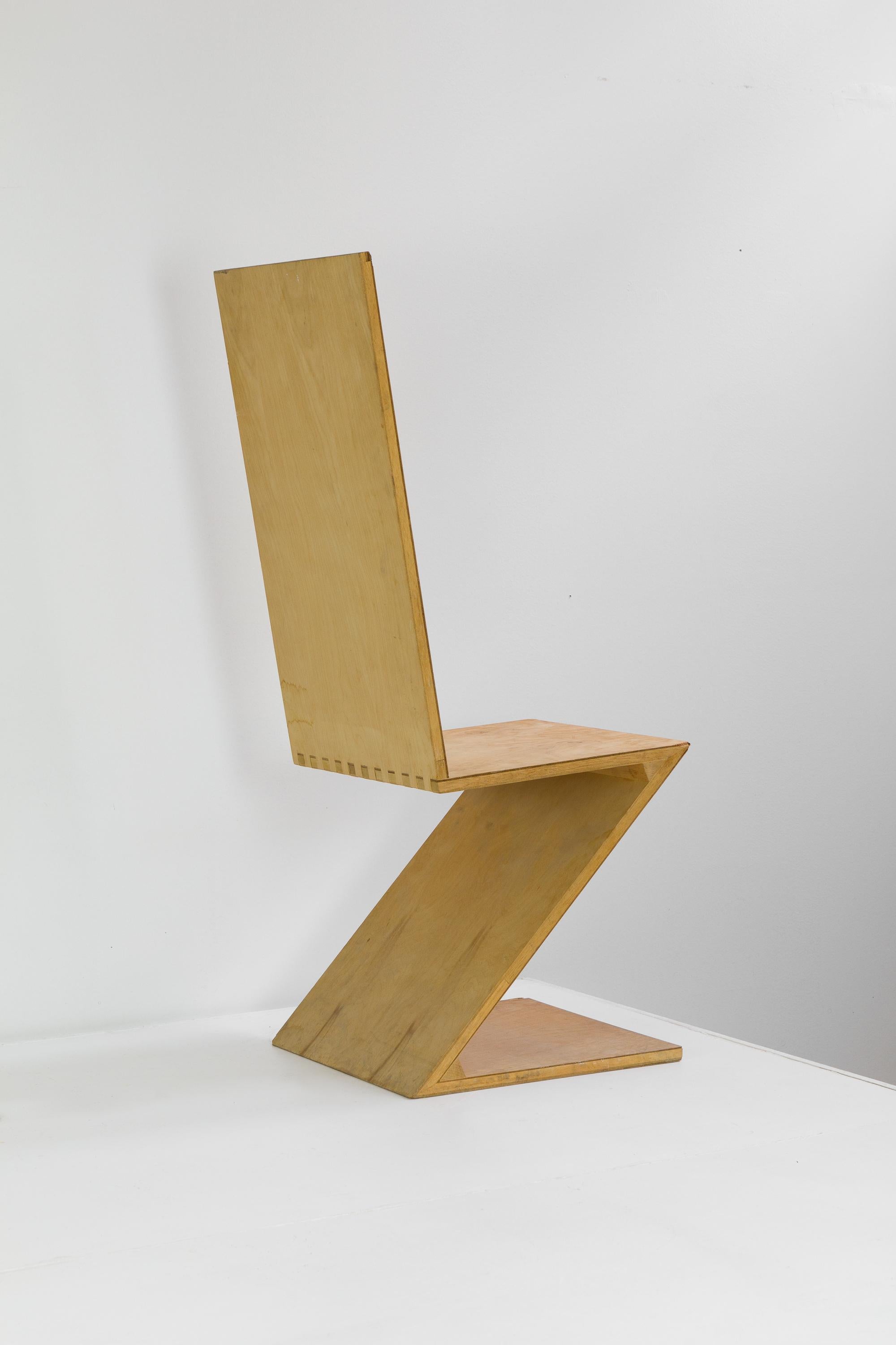 Vernacular handmade tall back Zig-Zag chairs after Gerrit Rietveld. Unfinished plywood veneer over block construction. Finger jointed, wedged and very strong. Two available.