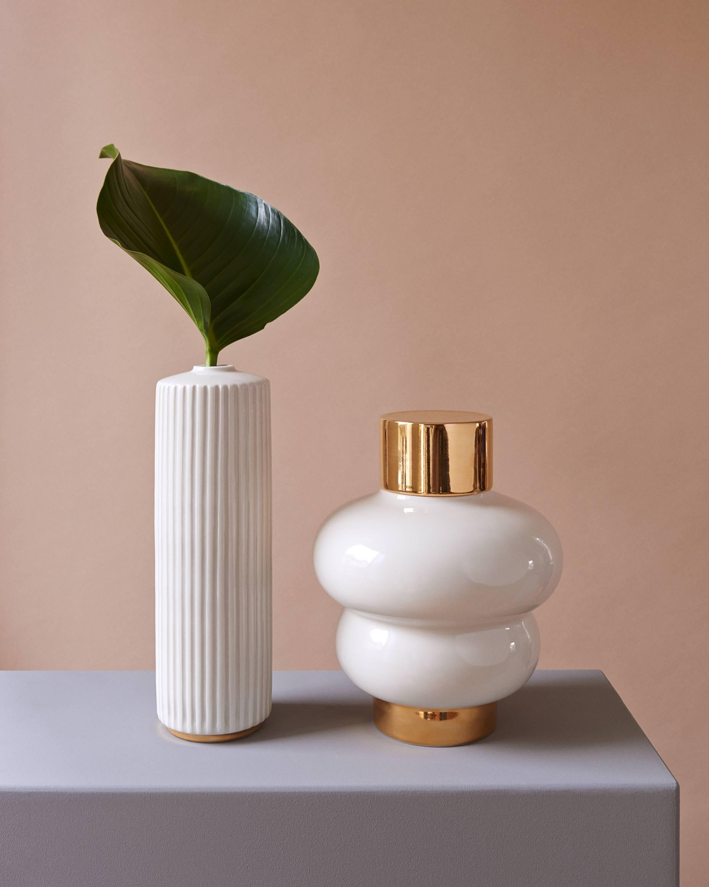 This hand-thrown porcelain Vase is a contemporary and functional stand out piece.  
The vase is made of glossy white porcelain with a 24k gold base. The vase has a size of Diameter 25cm, Height 33cm. 

The first ATLAS CRAFTS collection is thrown by