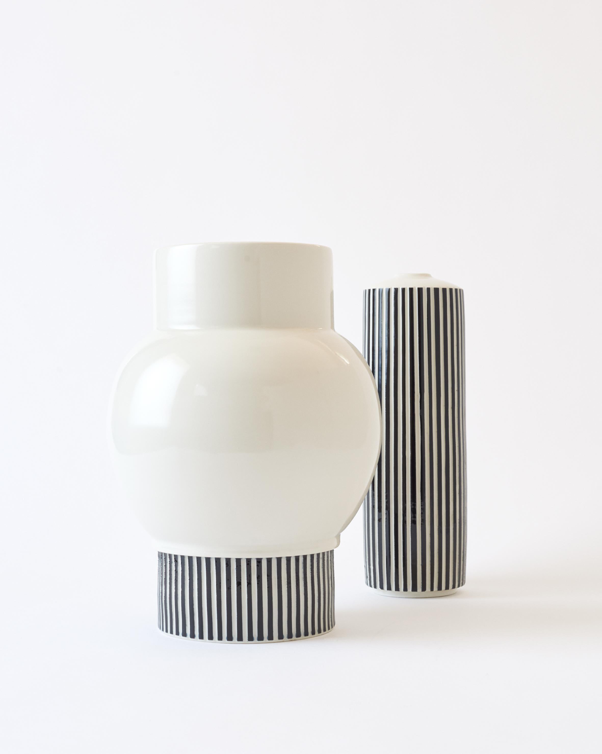 This hand-thrown porcelain vase is a contemporary and functional stand out piece. The vase is made of glossy white porcelain with a hand-carved striped base. The vase has a size of diameter 22.5cm, height 32cm

The first Atlas Crafts collection is