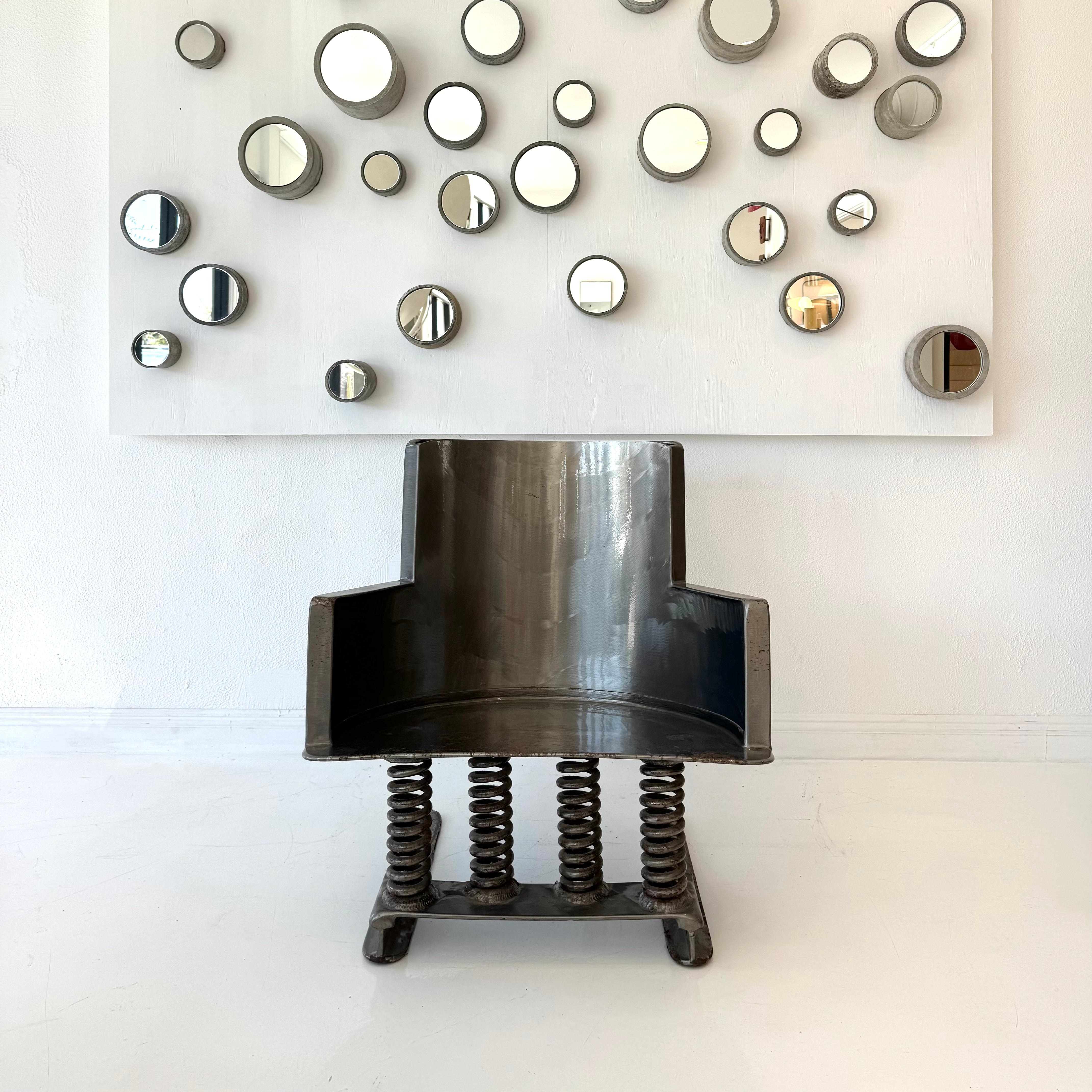 Incredible, hand-crafted steel rocking chair. Cantilevered design supported by four substantial coils underneath, allowing for quite amount of give under weight. Incredibly sturdy. Signed and dated 2002. Extraordinarily unique piece, only a few were