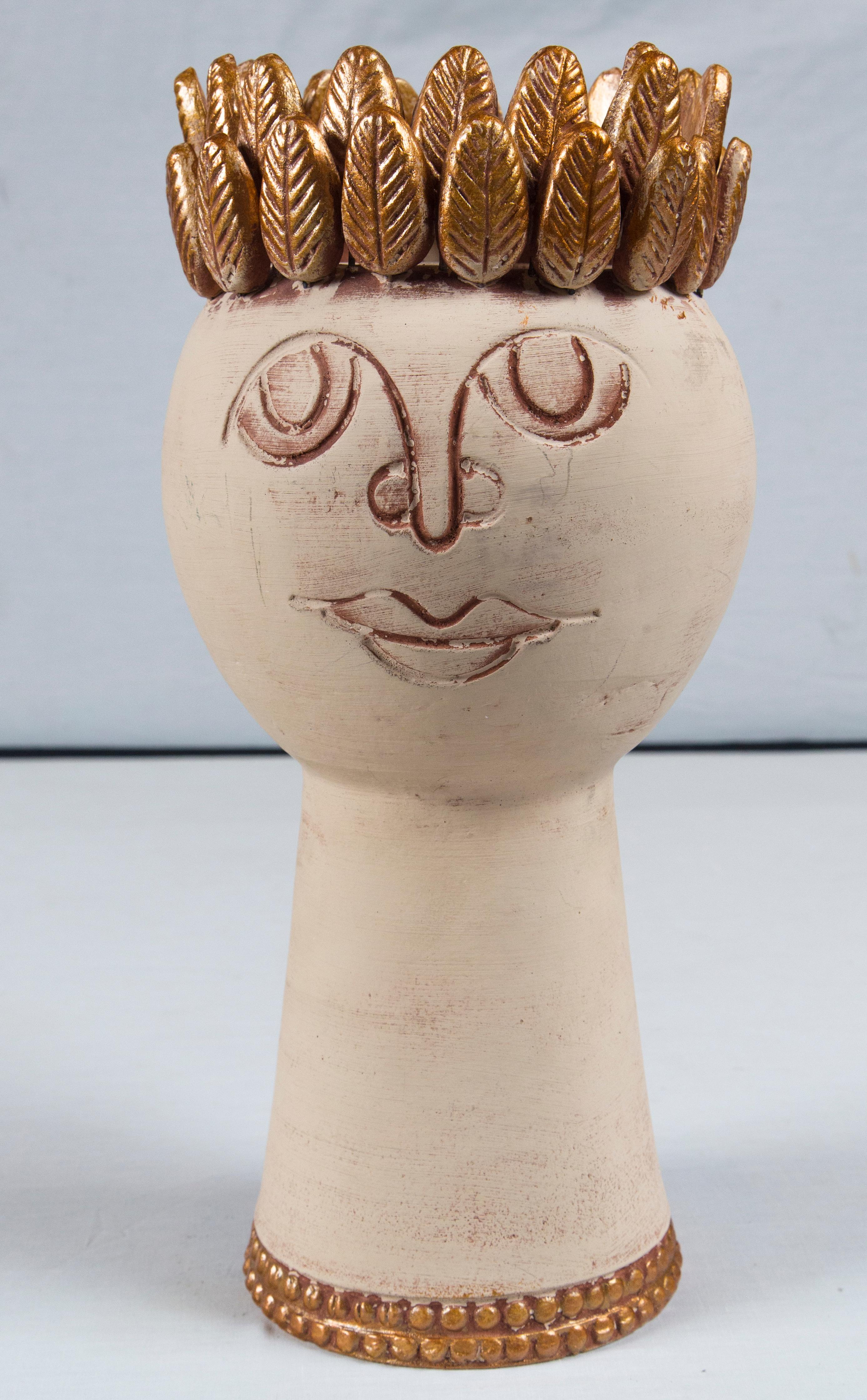Handmade pottery head vessel, off-white and bronze colored with a bronze laurel leaf crown.