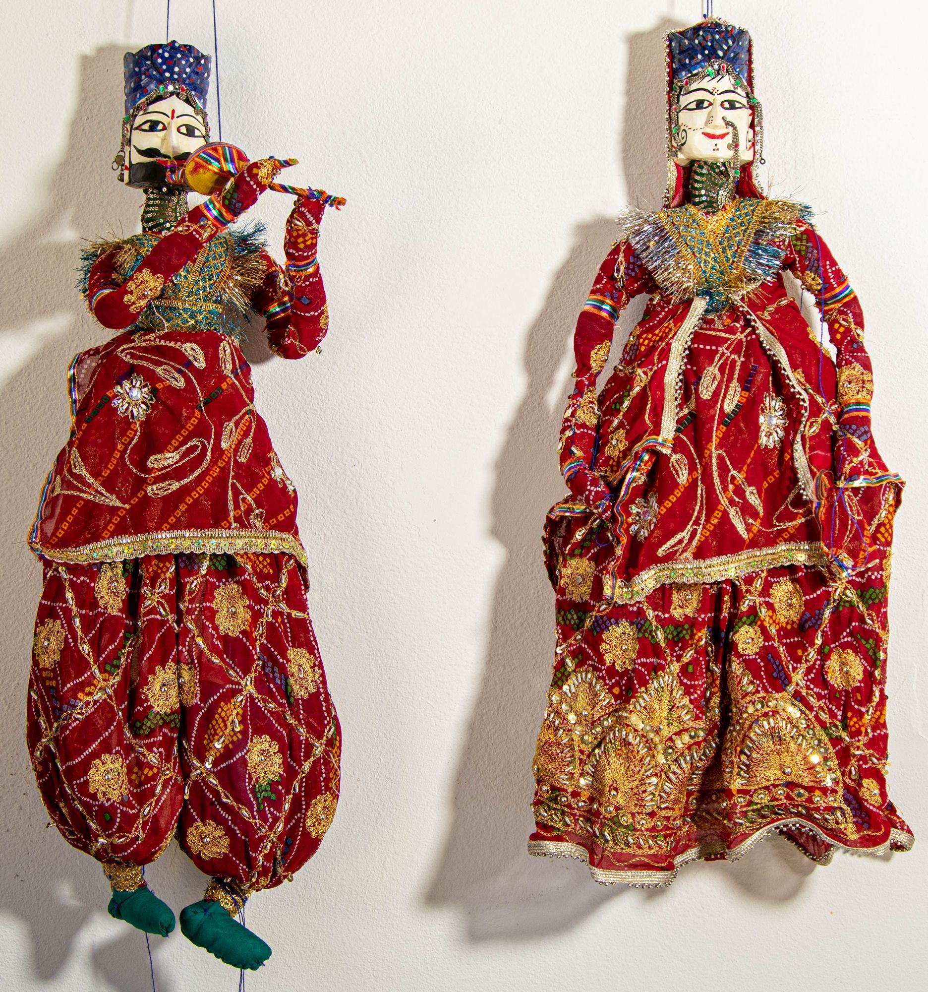 Large pair of vintage 1950s string marionettes, these magnificent Rajasthani Kathputli puppets came from the vibrant state of Rajasthan in northwestern India.
Meticulously handcrafted from wood and recycled silk sari fabric adorned in resplendent