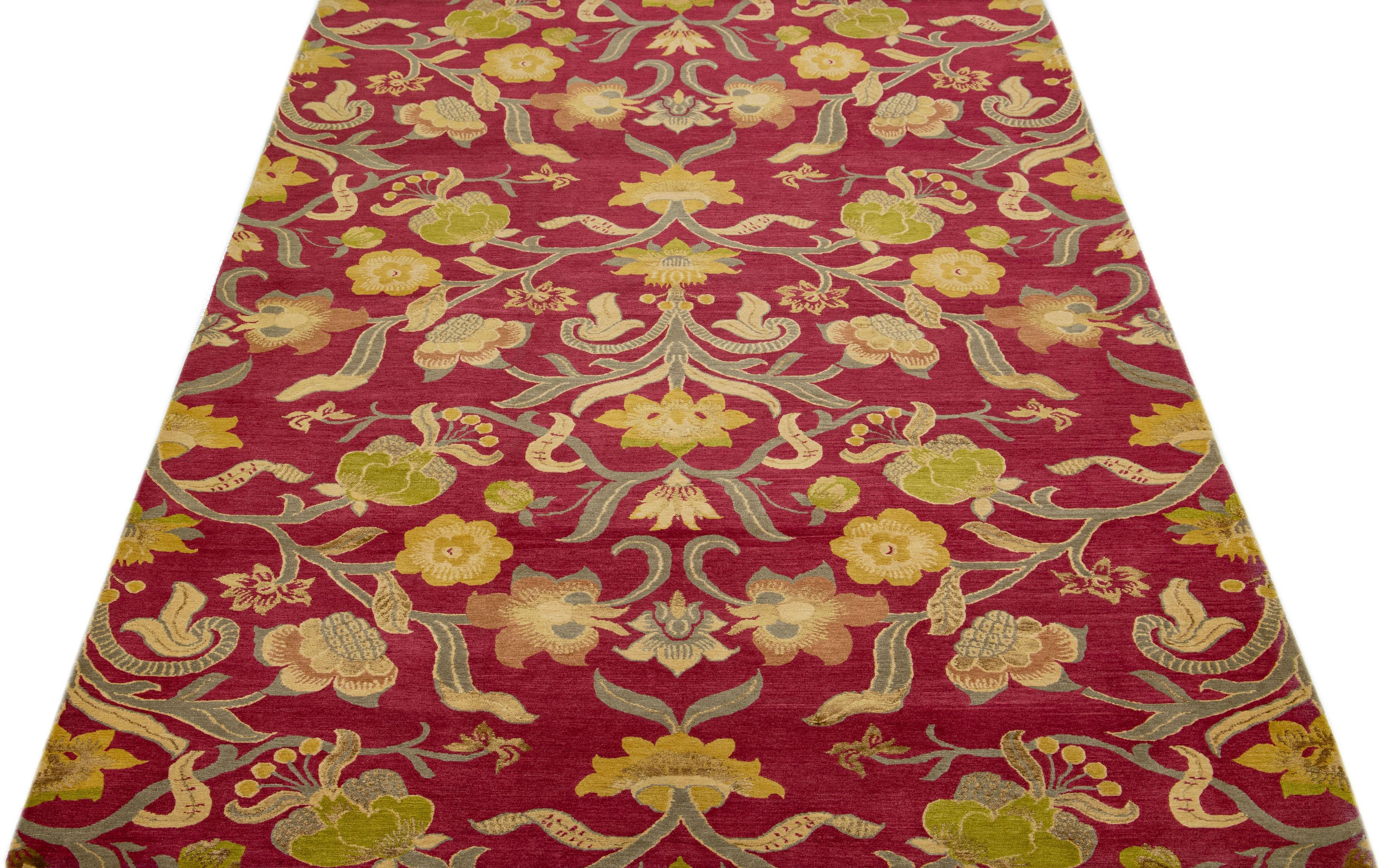 Crafted from premium quality wool and silk, this contemporary Nepalese rug features an intricate all-over scroll design in stunning shades of rich red, beautifully accentuated by luxurious golden details.

This rug measures 6'2