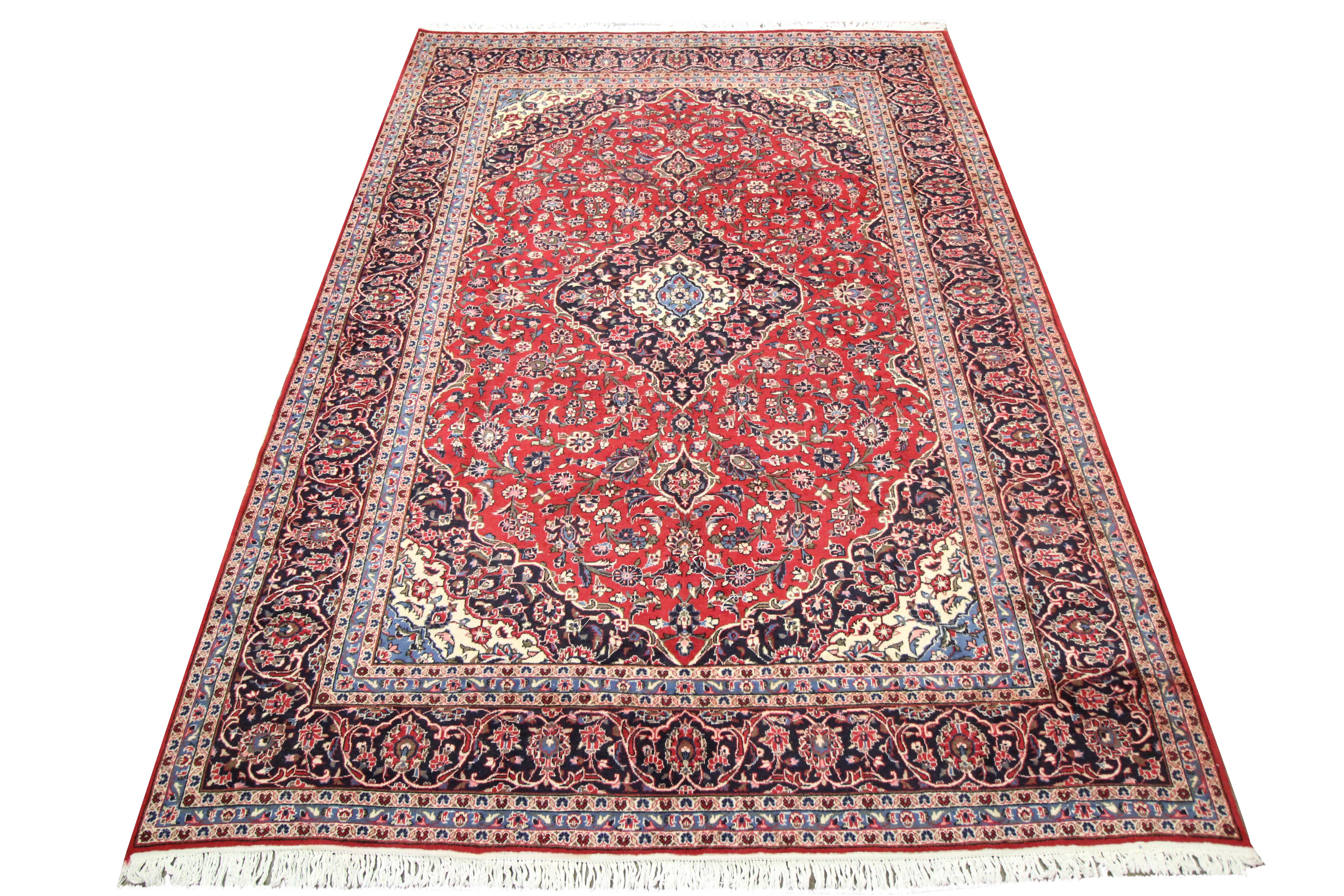 This traditional red wool area rug is a fantastic example of handwoven mid-20th century carpets. Featuring a rich red background and an array of accents including blue, beige and green that make up the highly decorative floral design. The colour