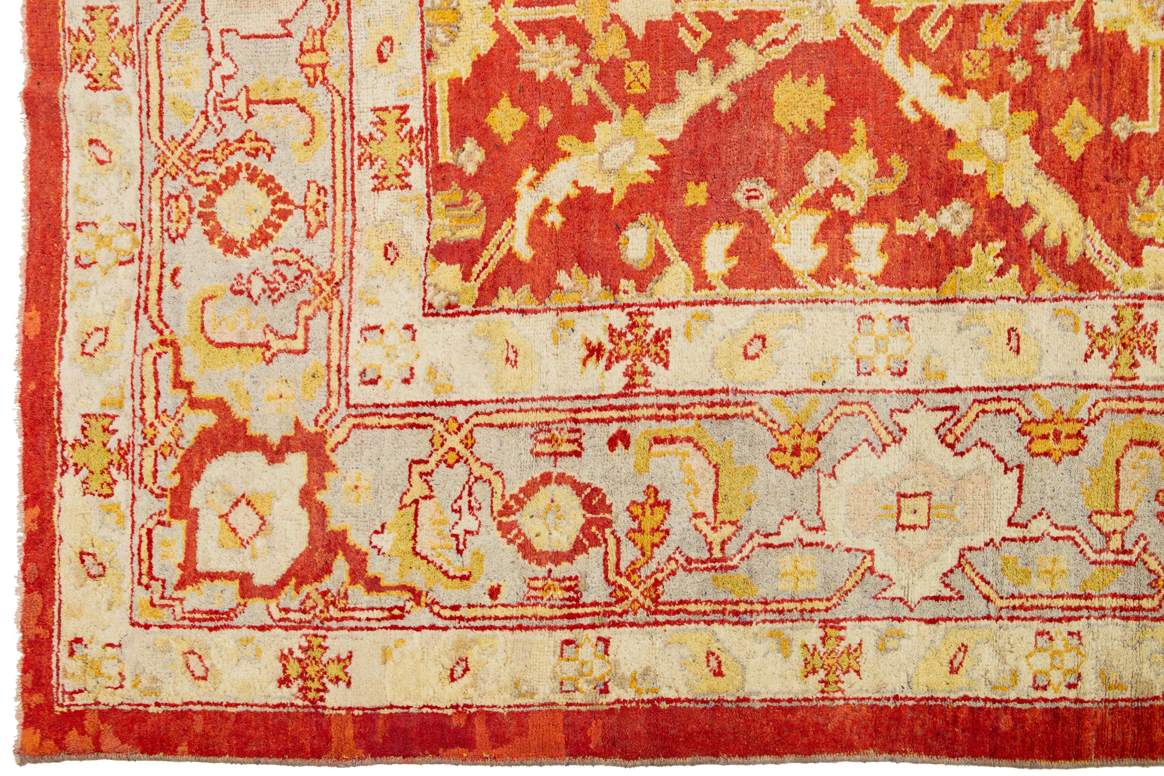 19th Century Handmade Red Turkish Oushak Wool Rug Featuring a Floral Pattern From The 1880's For Sale
