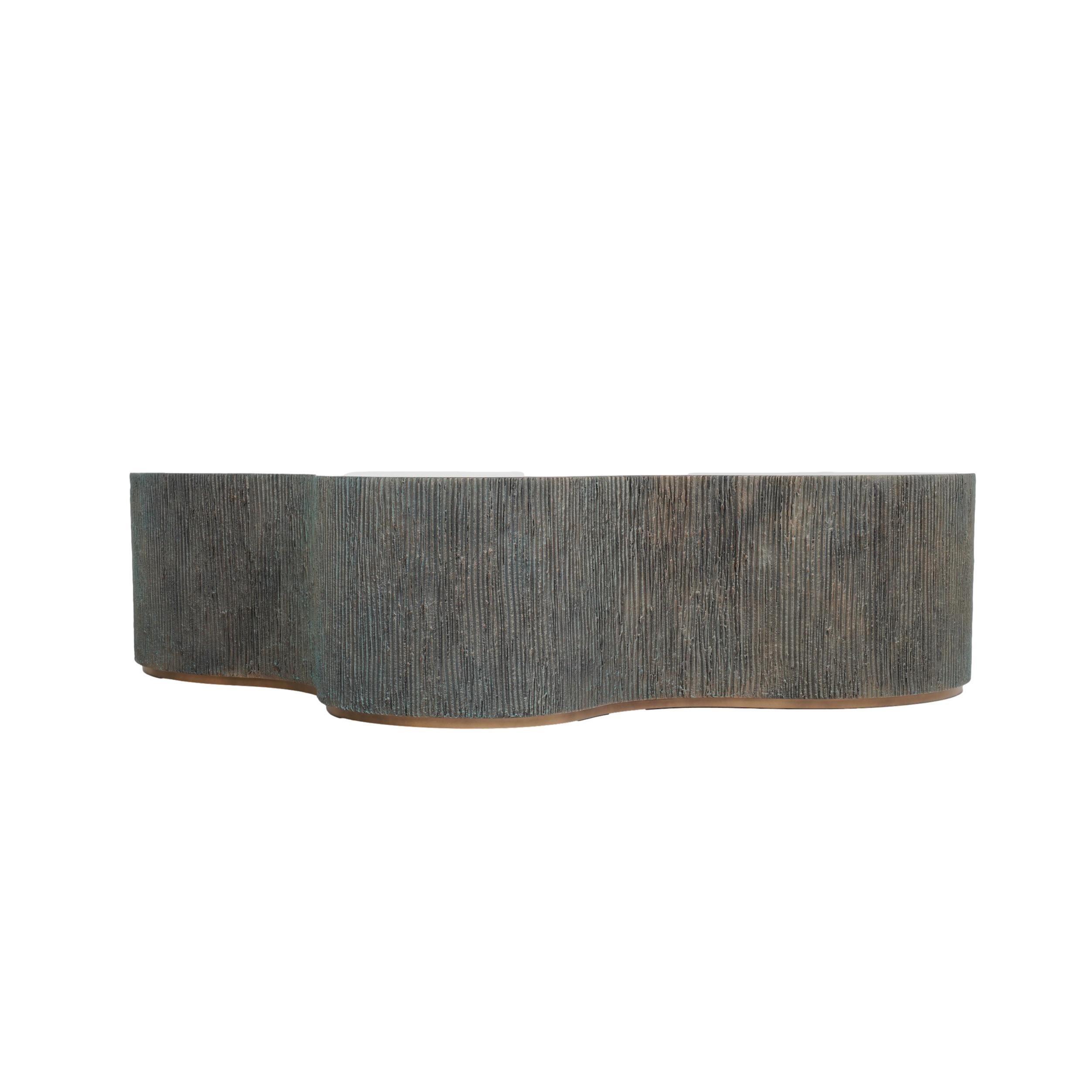 This handcrafted coffee table features a striking blend of materials. Its lightweight, yet durable, fiberglass-reinforced resin base boasts a brass-toned 