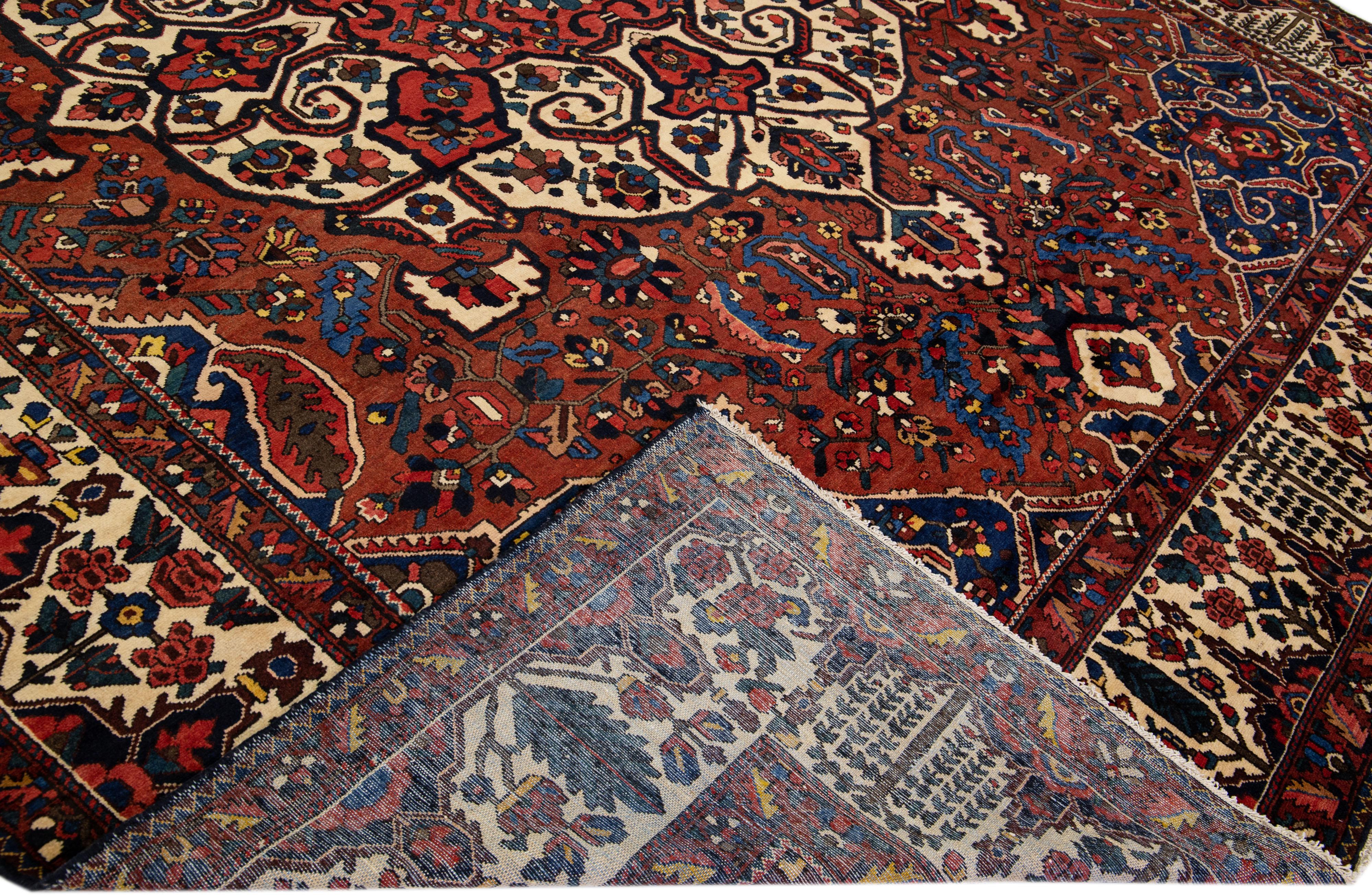 20th Century Handmade Rosette Antique Persian Bakhtiari Wool Rug With Red Color Field For Sale