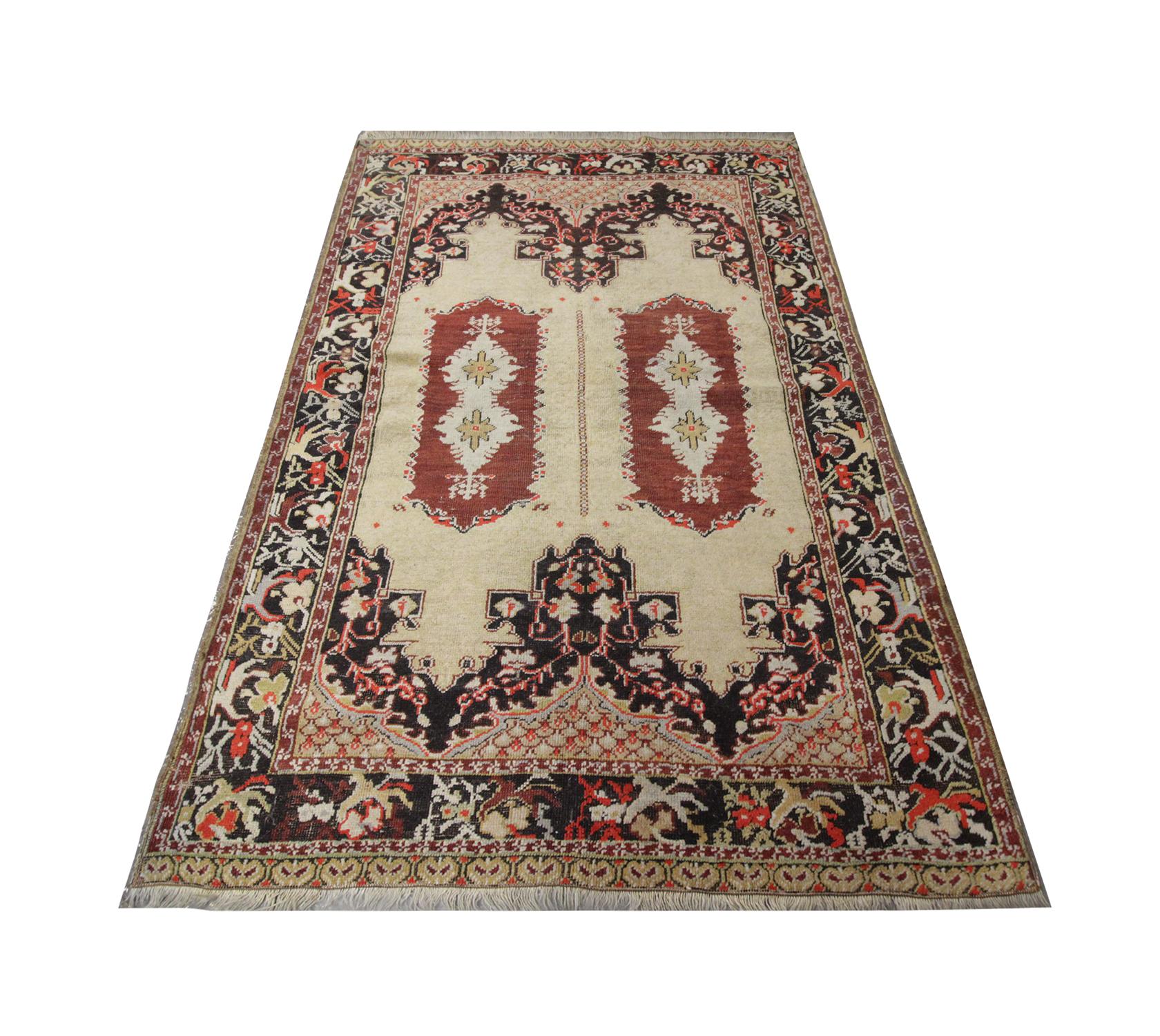 Handmade carpet with two central medallions draw you into this beautiful antique Turkish area rug, woven in deep orange on a cream background, the symmetric design is surrounded by a highly decorative floral pattern and repeat pattern border.