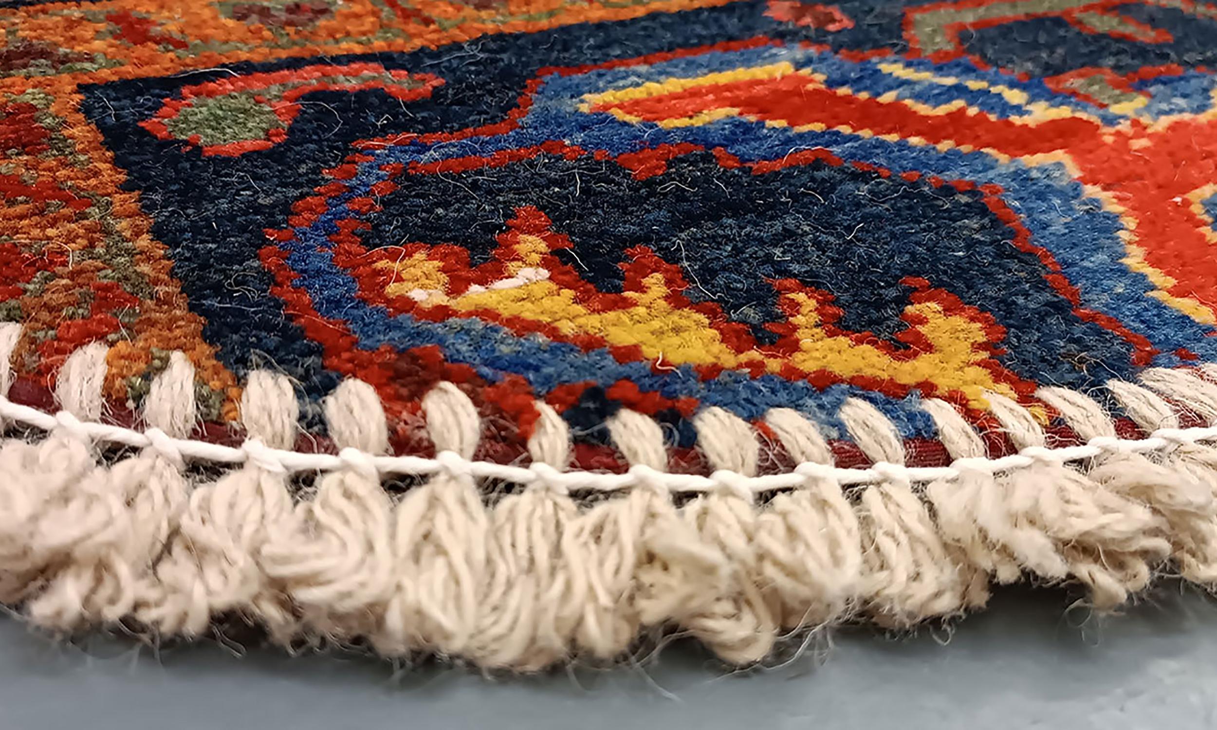 Handmade carpet Oriental rug featuring a traditional floral pattern woven in deep rich tones created by organic vegetable dyes on lamb wool, this little mat is perfect for any modern or traditional home doorway. This semi-circle entranceway doormat