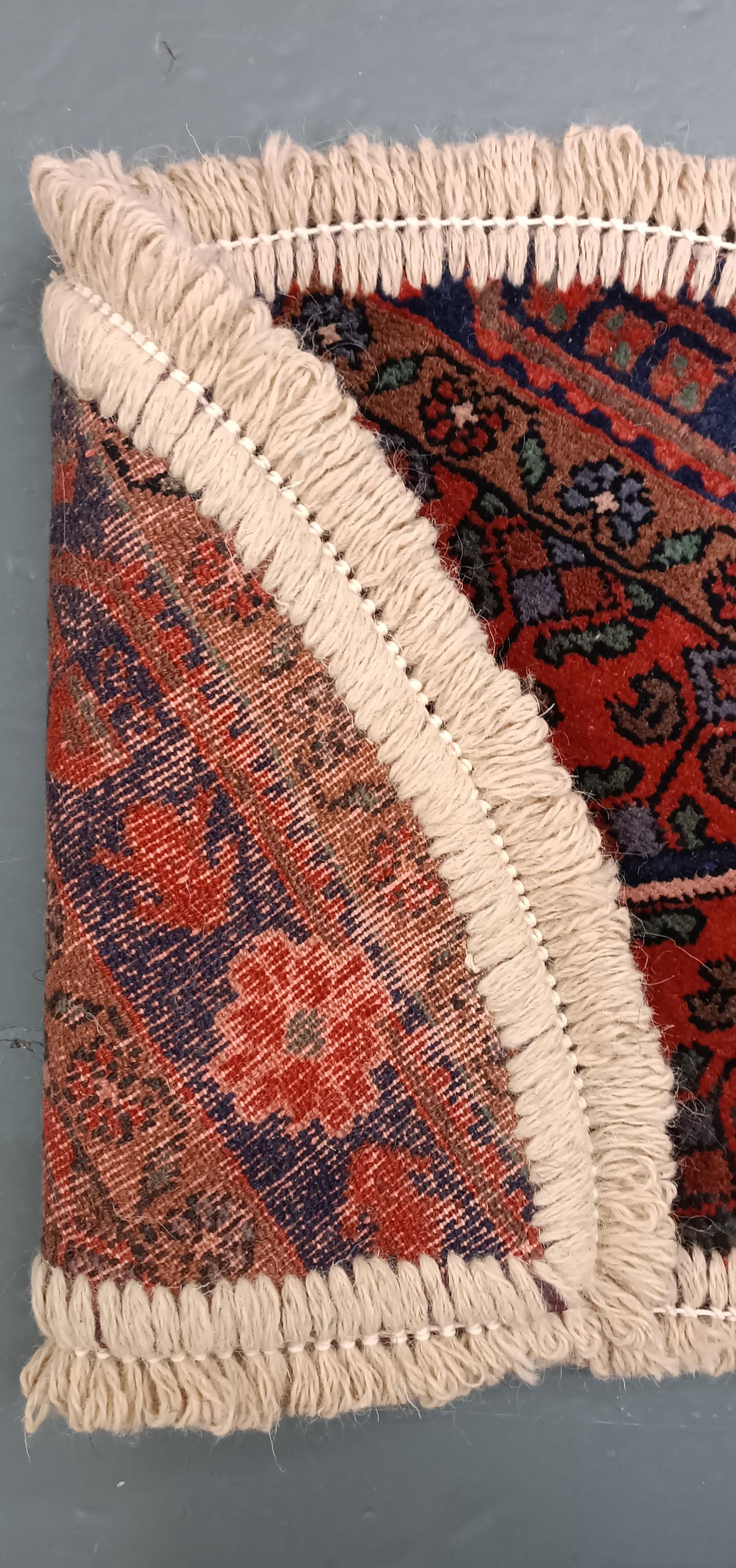 Handmade carpet Oriental rug featuring a traditional floral pattern woven in deep rich tones created by organic vegetable dyes on lamb wool, this little mat is perfect for any modern or traditional home doorway. This semi-circle entranceway doormat