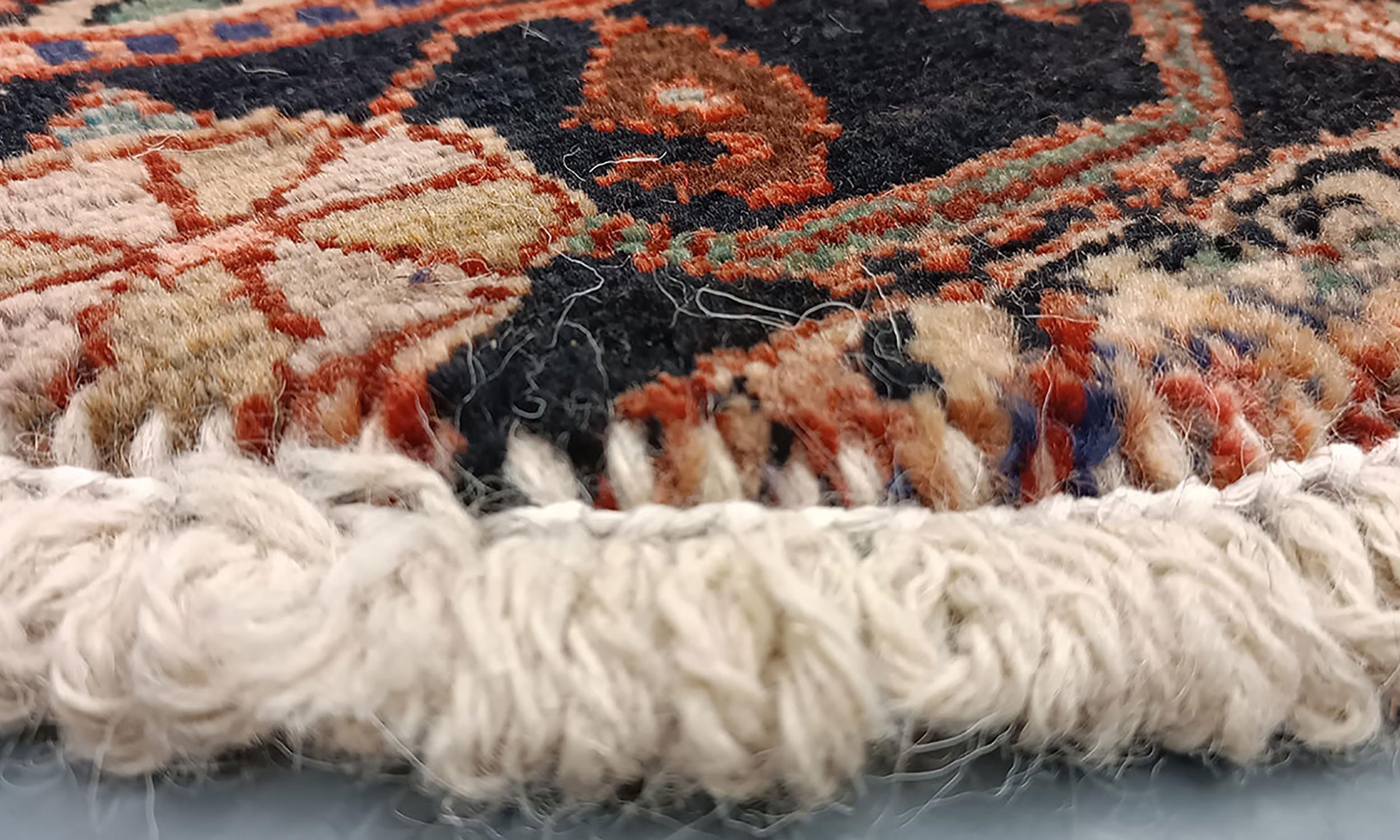 Handmade carpet Oriental rug featuring a traditional floral pattern woven in deep rich tones created by organic vegetable dyes on lamb wool, this little mat is perfect for any doorway in a modern or traditional home. This semi-circle entranceway