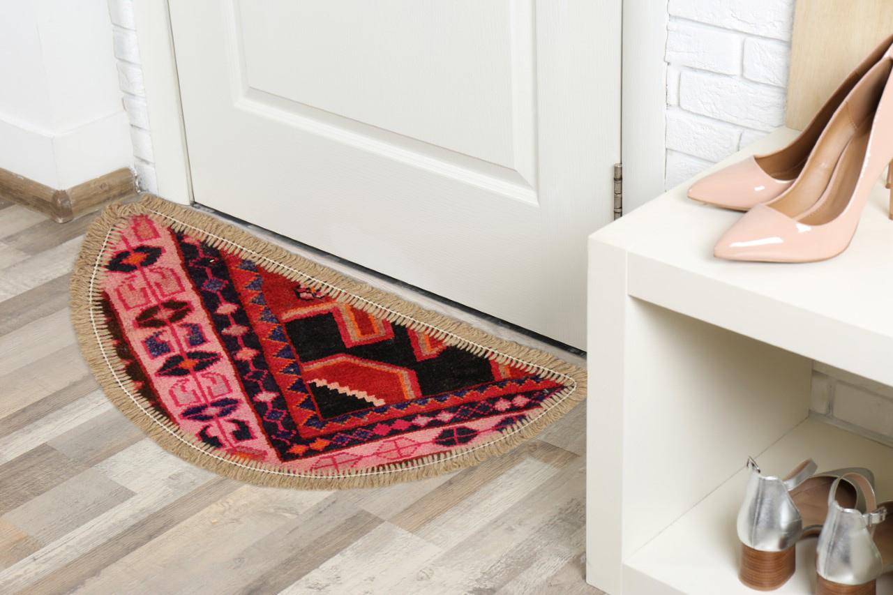 This semicircle entranceway doormat has been refurbished from a handmade carpet vintage rug- cut from large area rugs to create these small doormats, with handwoven fringe detail. Handspun cotton and wool have been used in the construction of these