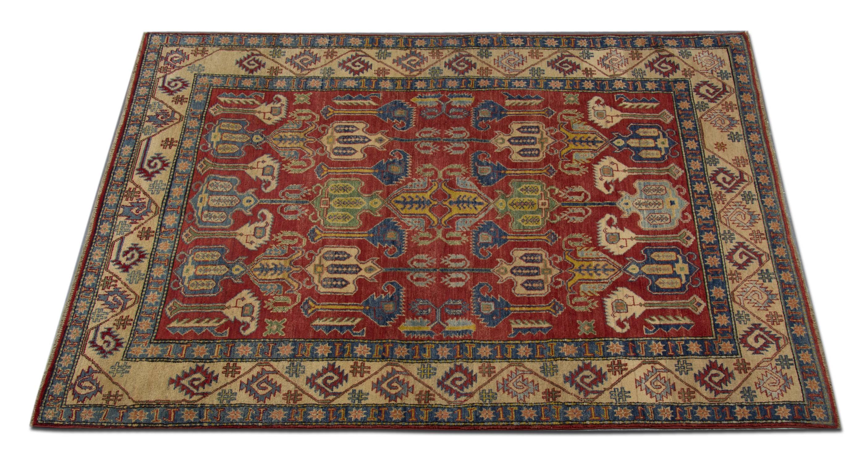 This is an example of a handwoven rug, which is featuring designs from the Kazak region. The Afghan weavers used top quality wool and cotton for the production of this red rug. This tribal rug features typical geometric rug patterns. There are a