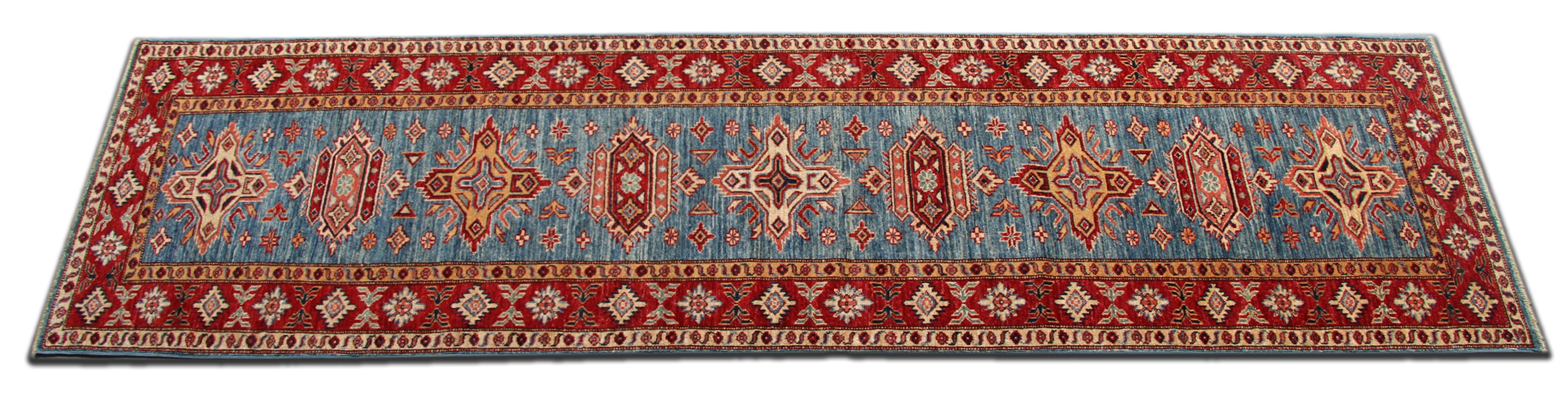 This handmade carpet runner's new traditional handwoven Kazak rug comes in a striking colour combination. This Blue rug has cream, red and caramel accent colours woven through both the centre and border. The pattern depicted on this hand-woven