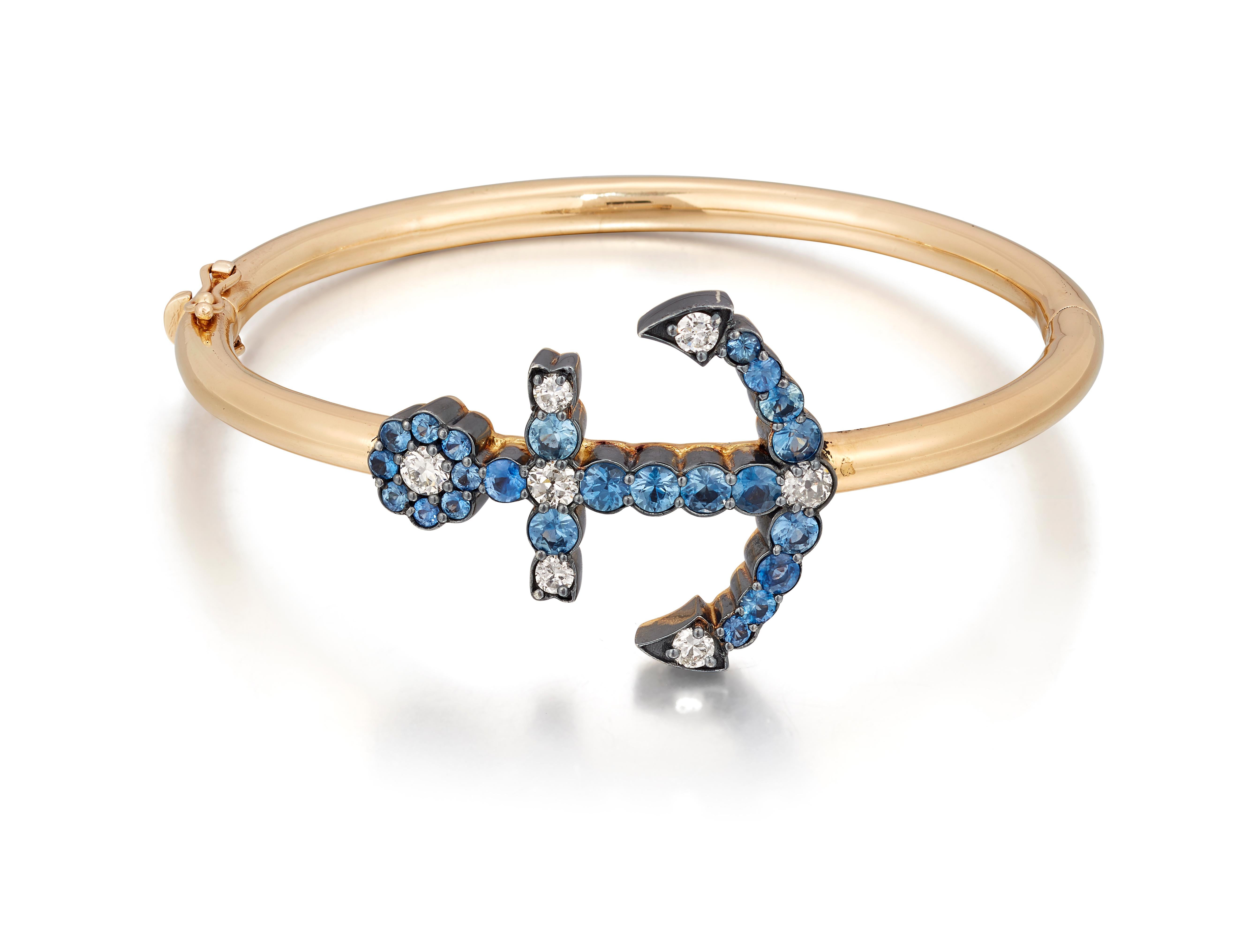 Beautifully crafted Anchor bangle set with Diamonds and Sapphire

The circular-cut Sapphire and old brilliant-cut Diamond anchor. Set in Silver and 18ct yellow gold, to a 18ct yellow gold bangle, anchor measuring 3.2cm long, inner circumference on