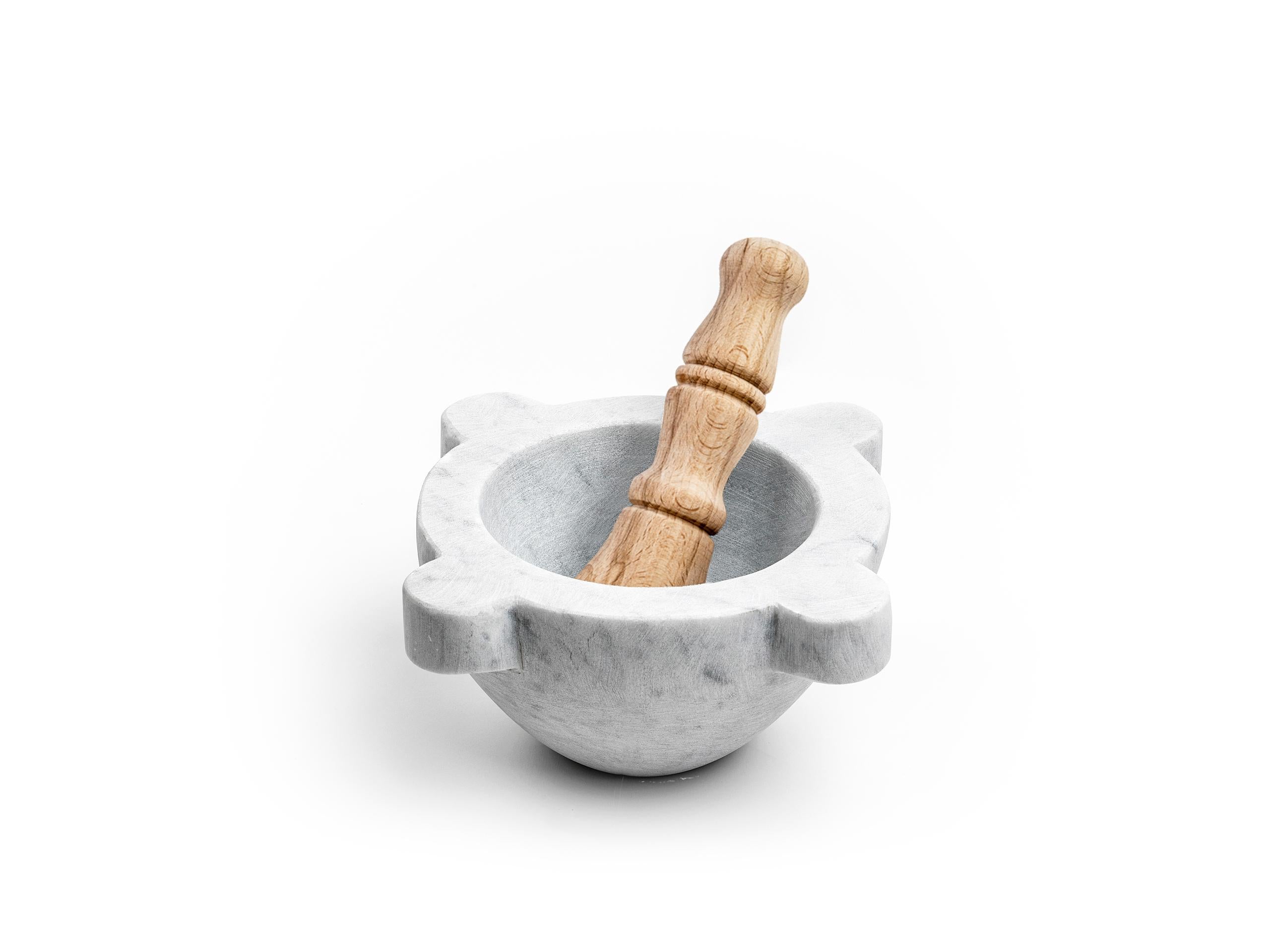 Satin white Carrara marble mortar with pestle in wood. 
The product can not be washed in dishwasher but needs to be cleaned with water or Marseille soap. It is certified for food use. It is a natural stone that tends to stain but this is part of
