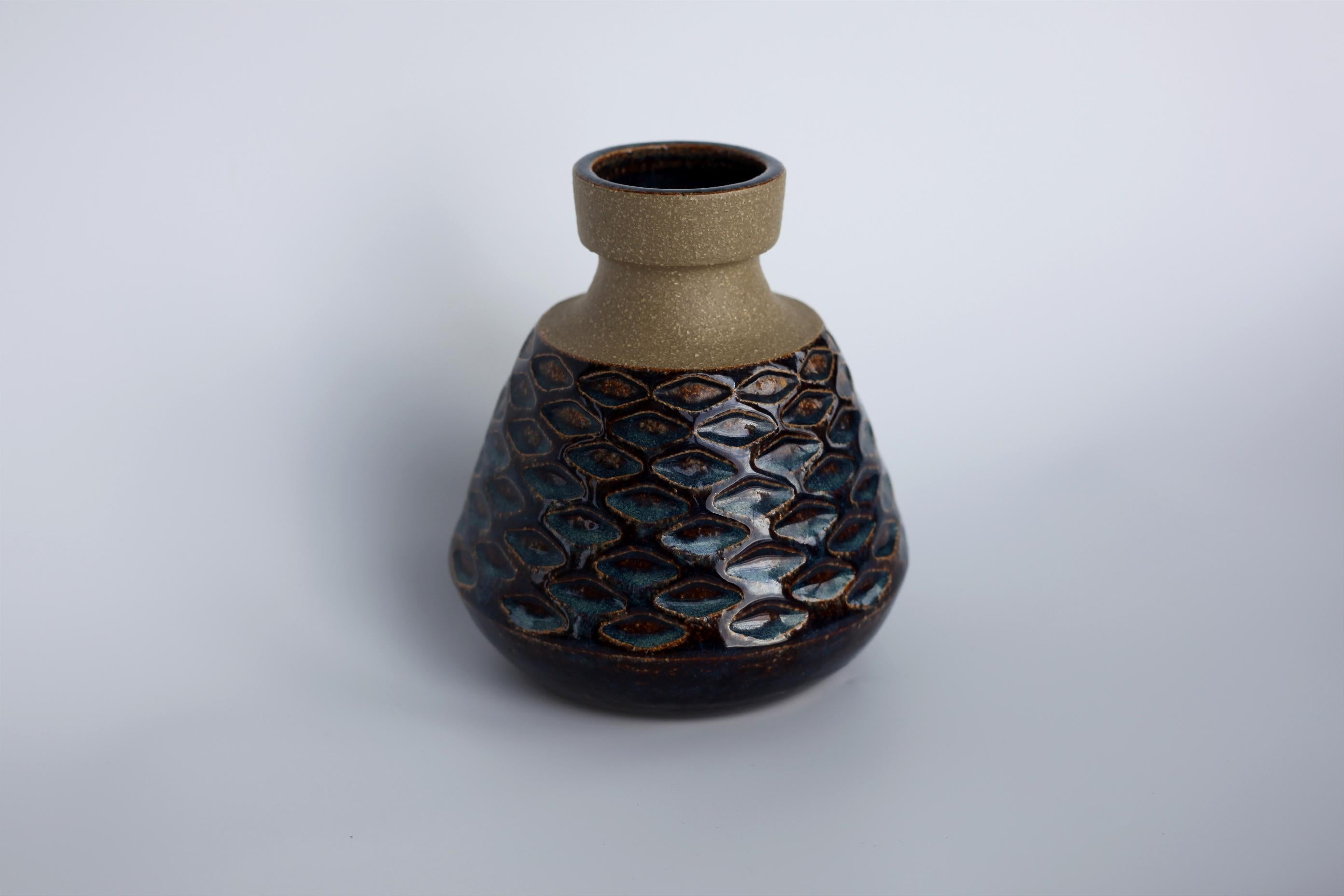 Vase made at the Scandinavian Søholm pottery on the Island of Bornholm by Einer Johanson. 

The island of Bornholm is the most Eastern point of Denmark and the Søholm pottery is one of the tree if not the most famous and well-known vase maker in