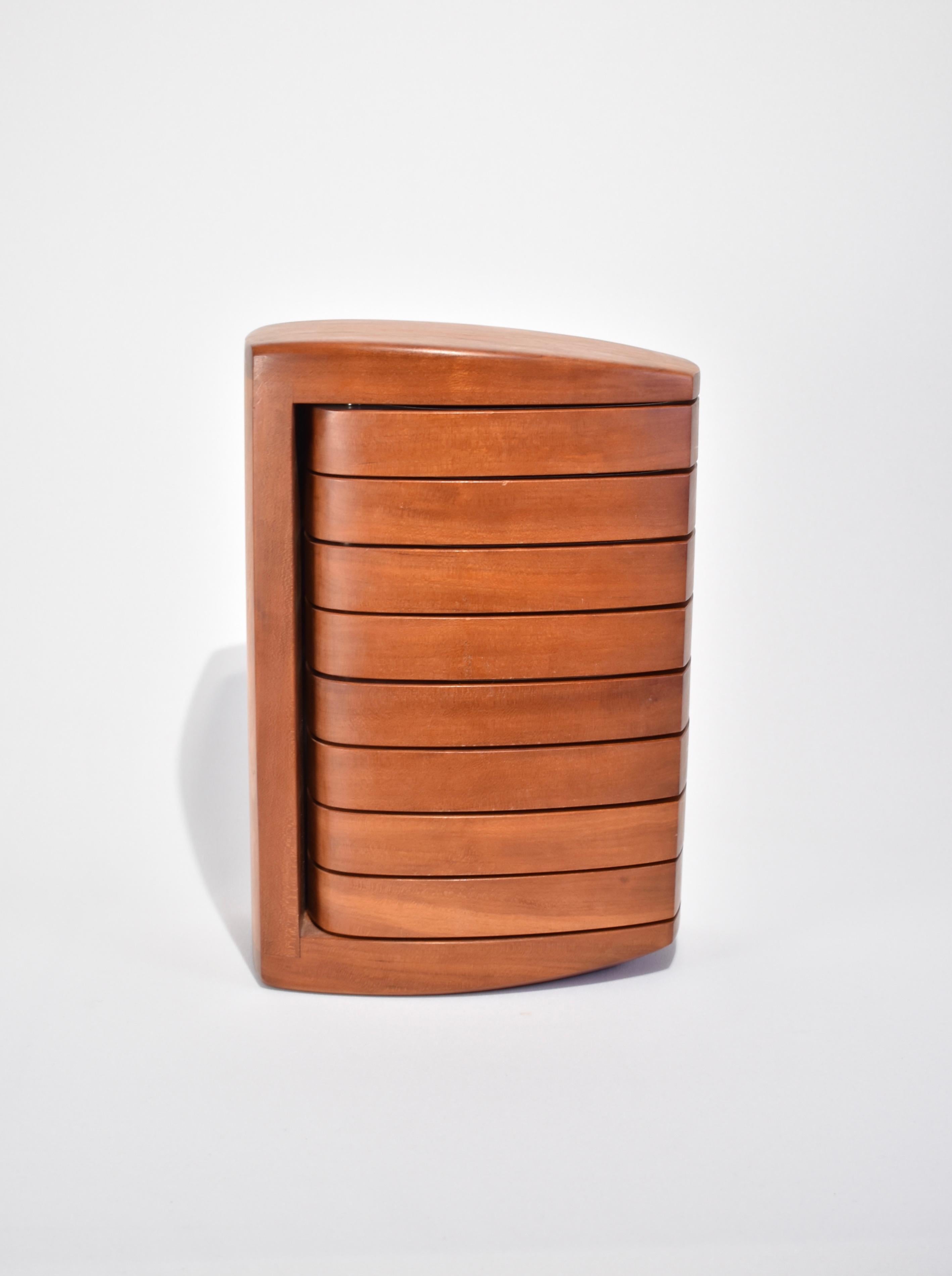 Stunning, sculptural wooden jewelry box with eight pivoting compartments lined in grey velvet. By Kellam studio, signed on base.