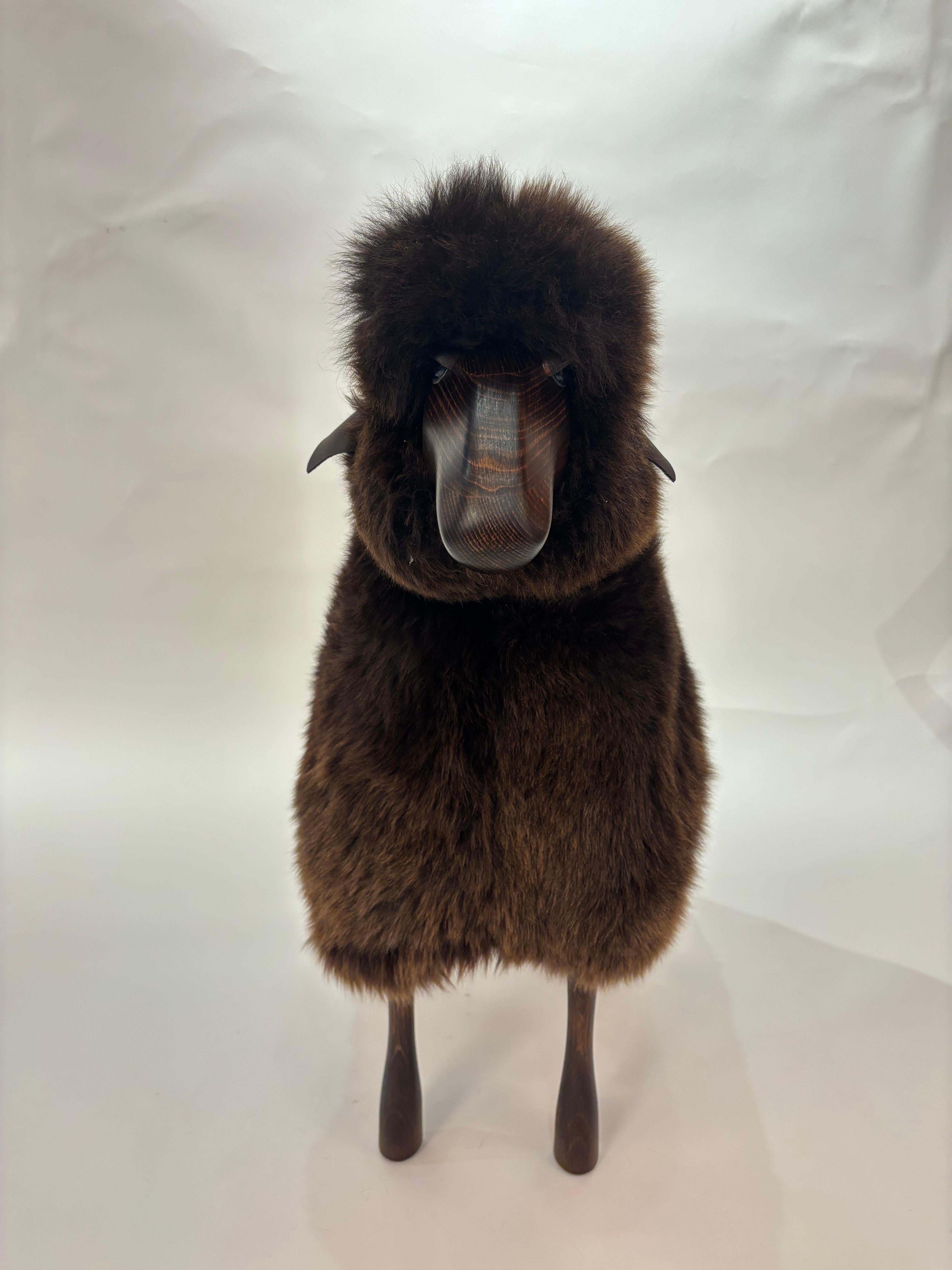 Handmade sheep in brown fur and teak coloured wood. Designed by German artist and designer Hans-Peter Krafft, produced in Germany by Meier Germany. 

Originally used as a stool, the sheep is also a beautiful sculptural object. 

Materials among