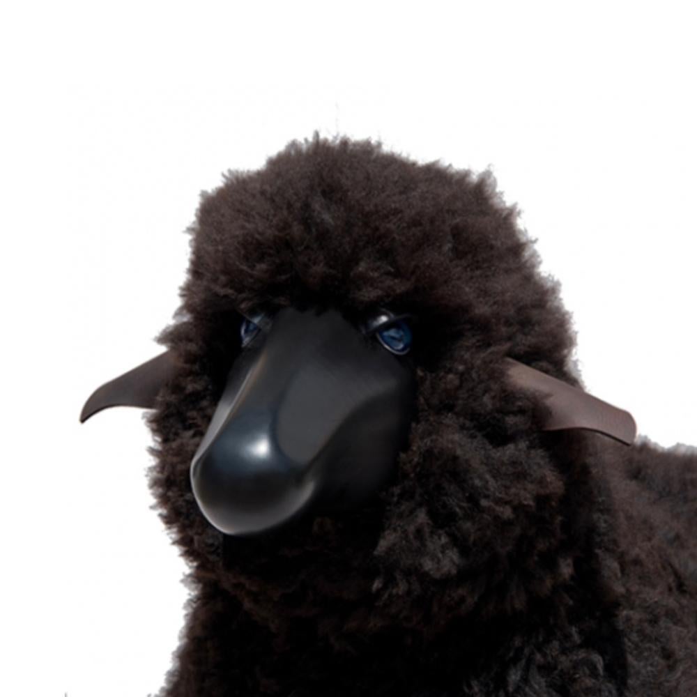 Handmade sheep in curly brown fur and black colored wood. Designed by German artist and designer Hans-Peter Krafft, produced in Germany by Meier Germany. 

Originally used as a stool, the sheep is also a beautiful sculptural object. 

Materials