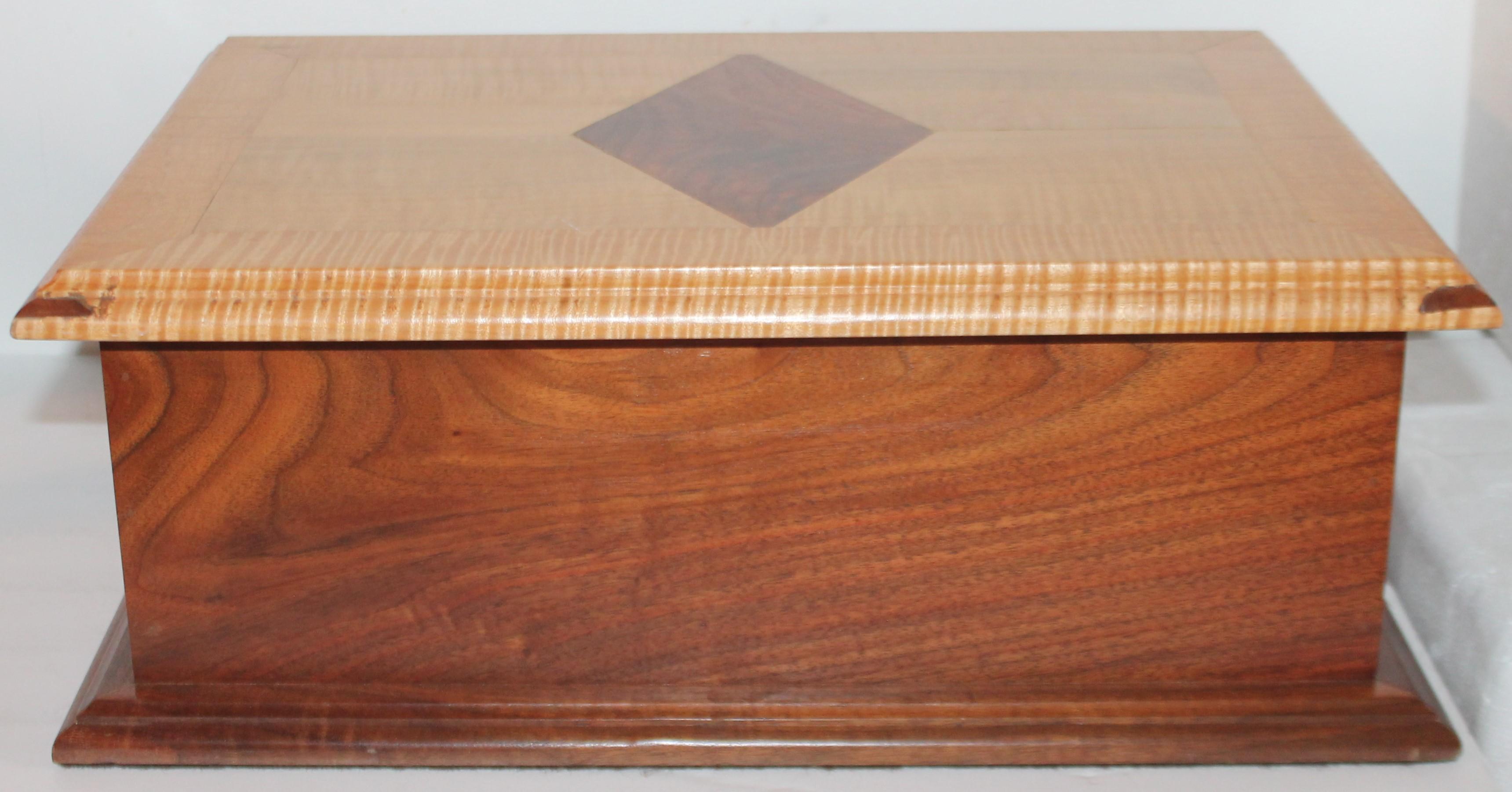 Handmade walnut and tiger eye maple silver chest with drawer. This is more contemporary handmade chest with a lift top.