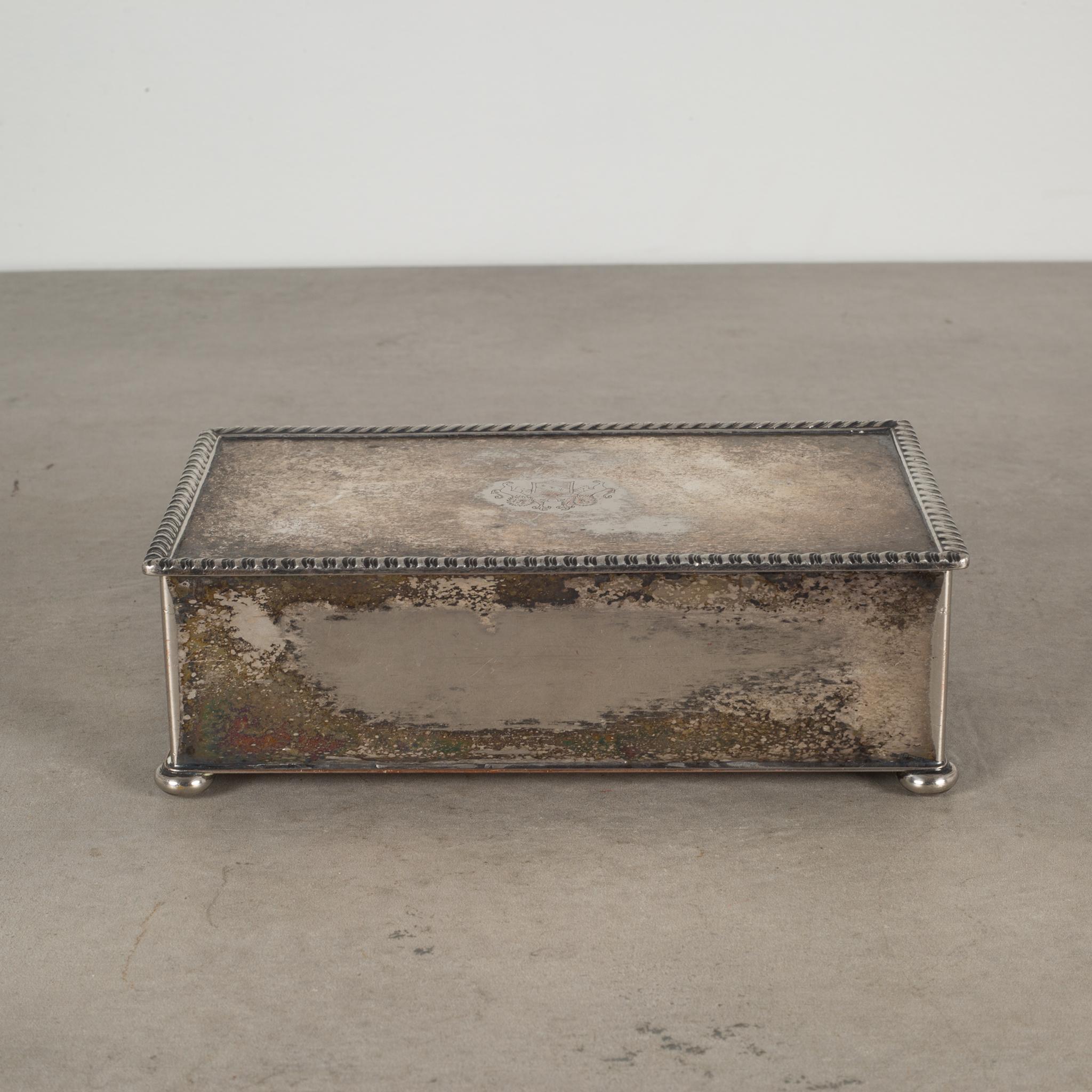 About

A silver plate footed box embossed with an English crest and lined with sandlewood. Stamped 