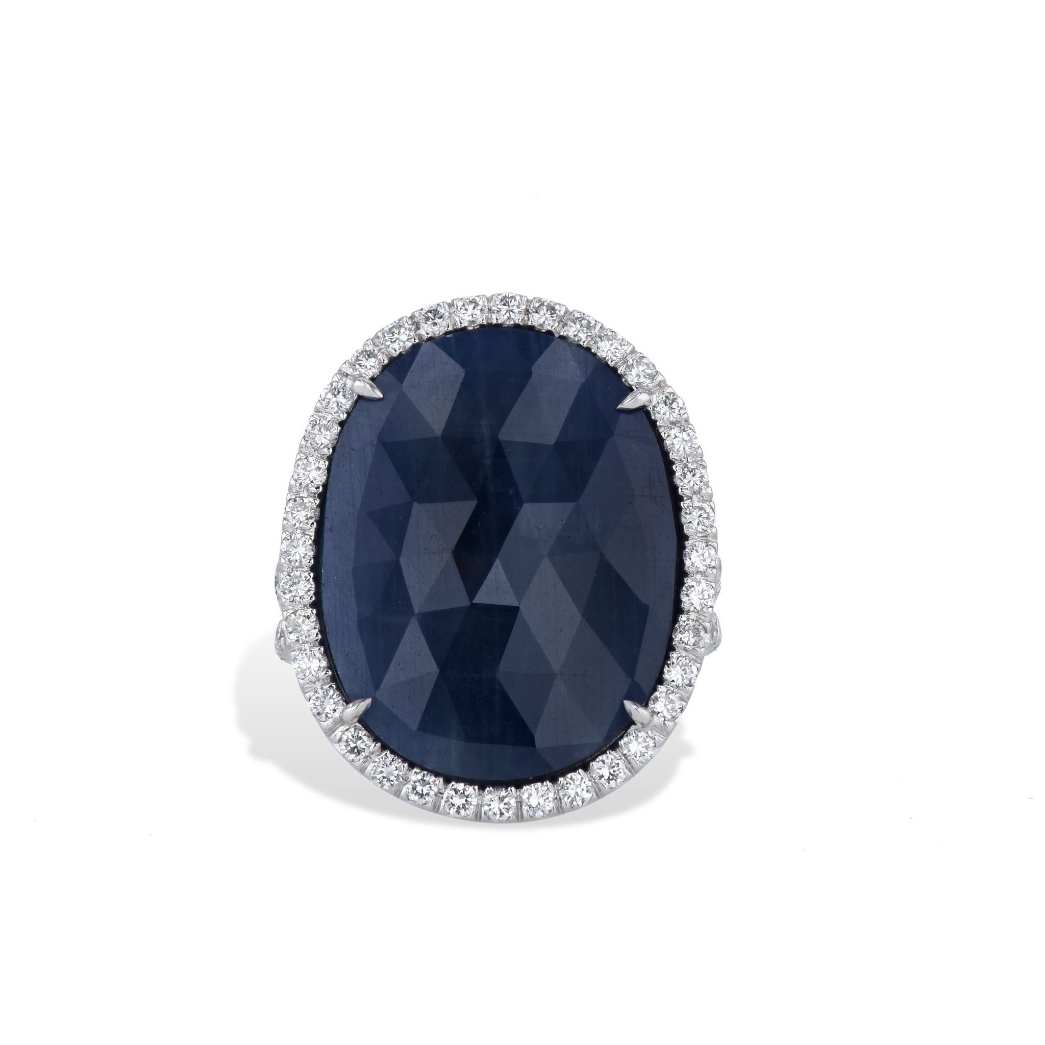 Become enchanted in this timeless beauty with this captivating beautiful blue sapphire slice and pave diamond ring. 
Beautifully handcrafted in 18 karat white gold, which features an alluring 19.94 carat sapphire slice at its center with shimmering