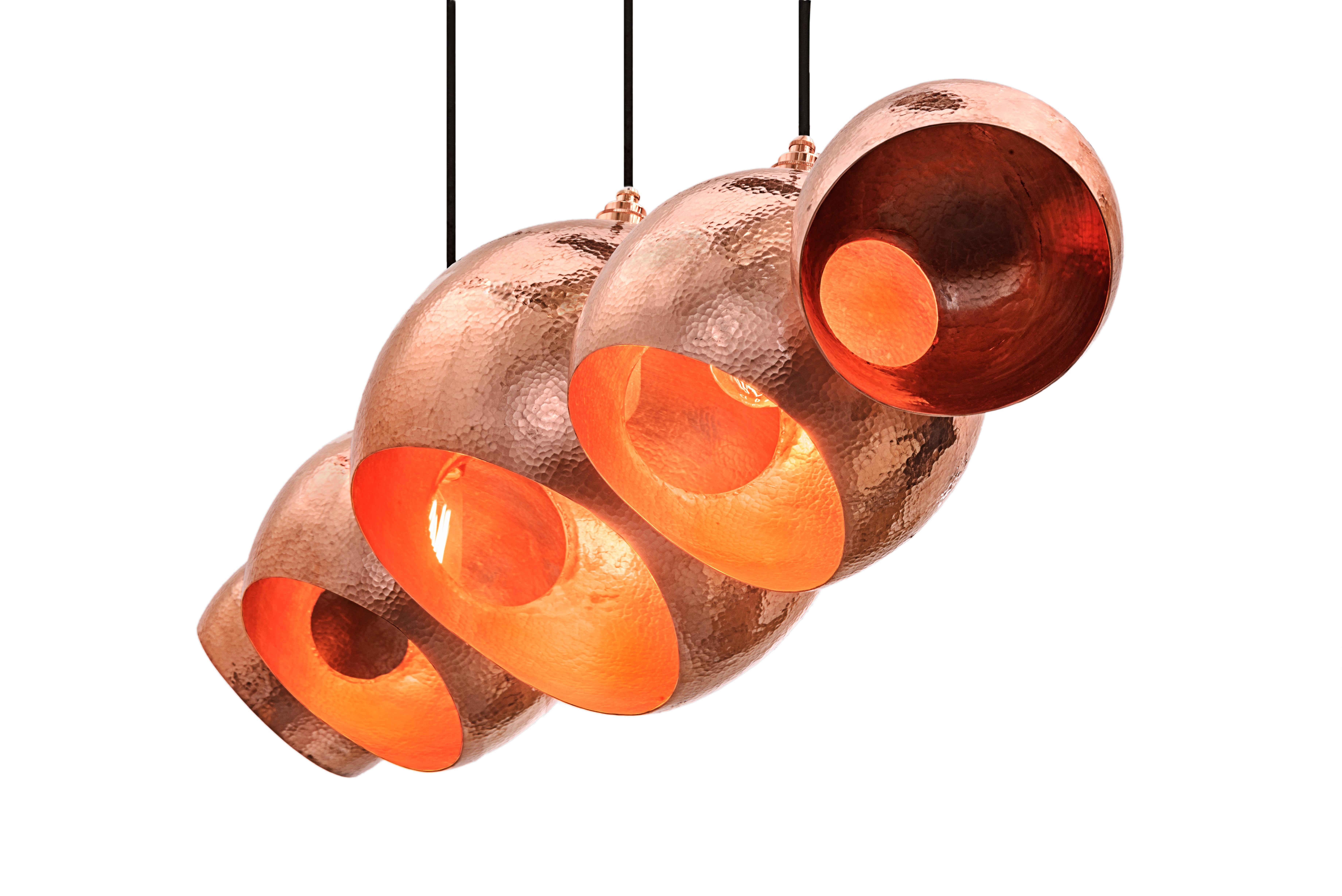 The Alquimia Orb: Levitate by Luminosa is a handmade solid copper pendant chandelier in polished hammer finish designed for the modern interior. The chandelier is polished on both the inside and outside creating a brilliant prominence. The Leviatate
