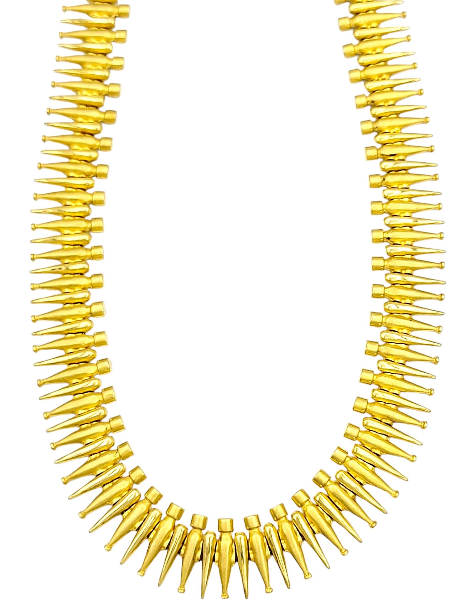 This exquisite 18 karat yellow gold choker necklace exudes timeless sophistication. The narrow link design seamlessly blends brushed and polished gold links, creating a striking contrast that catches and reflects light with every movement. The