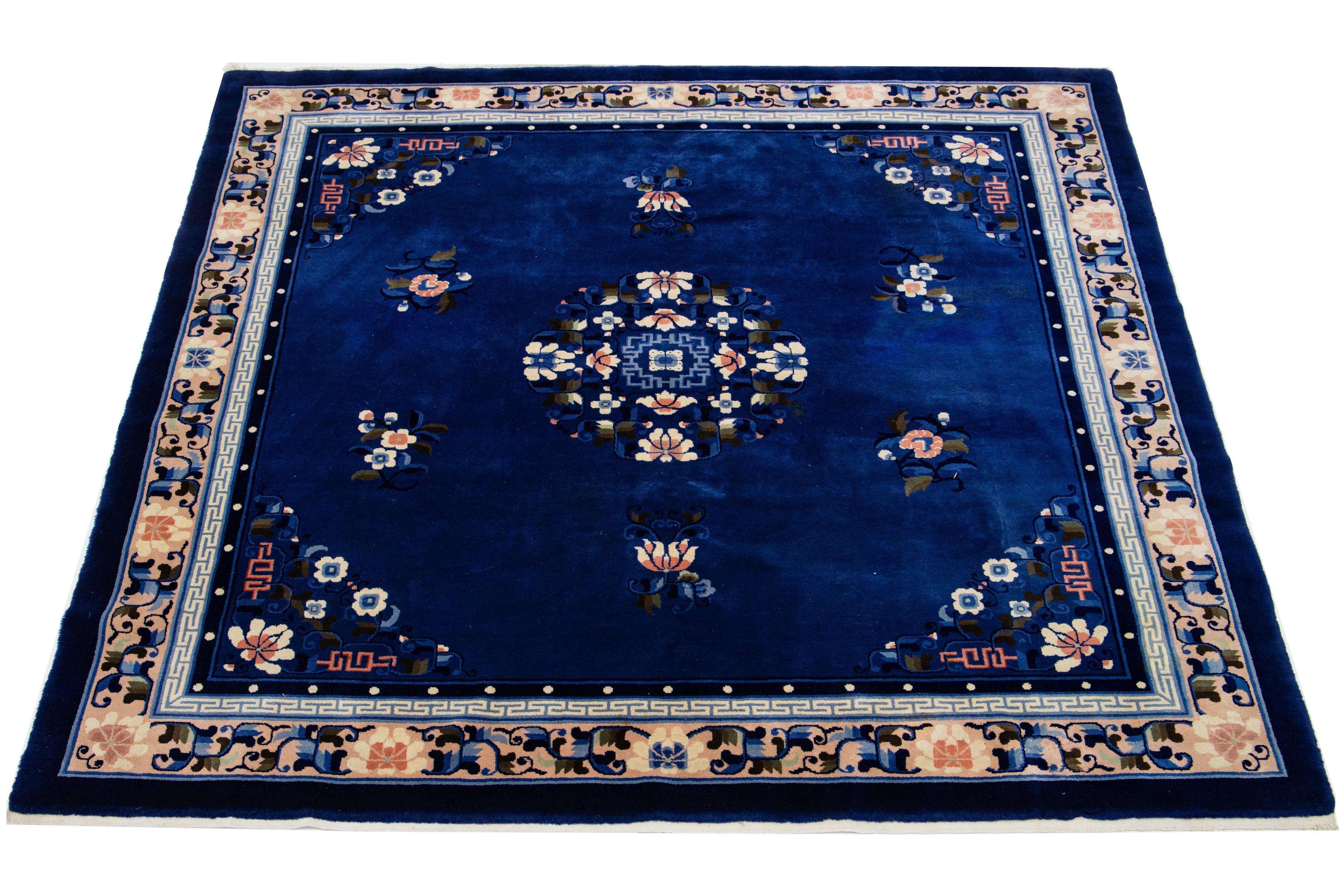 This beautiful hand-knotted wool rug showcases a navy blue center framed by a multicolored border in a stunning Chinese floral pattern.

This rug measures 7' x 7'2