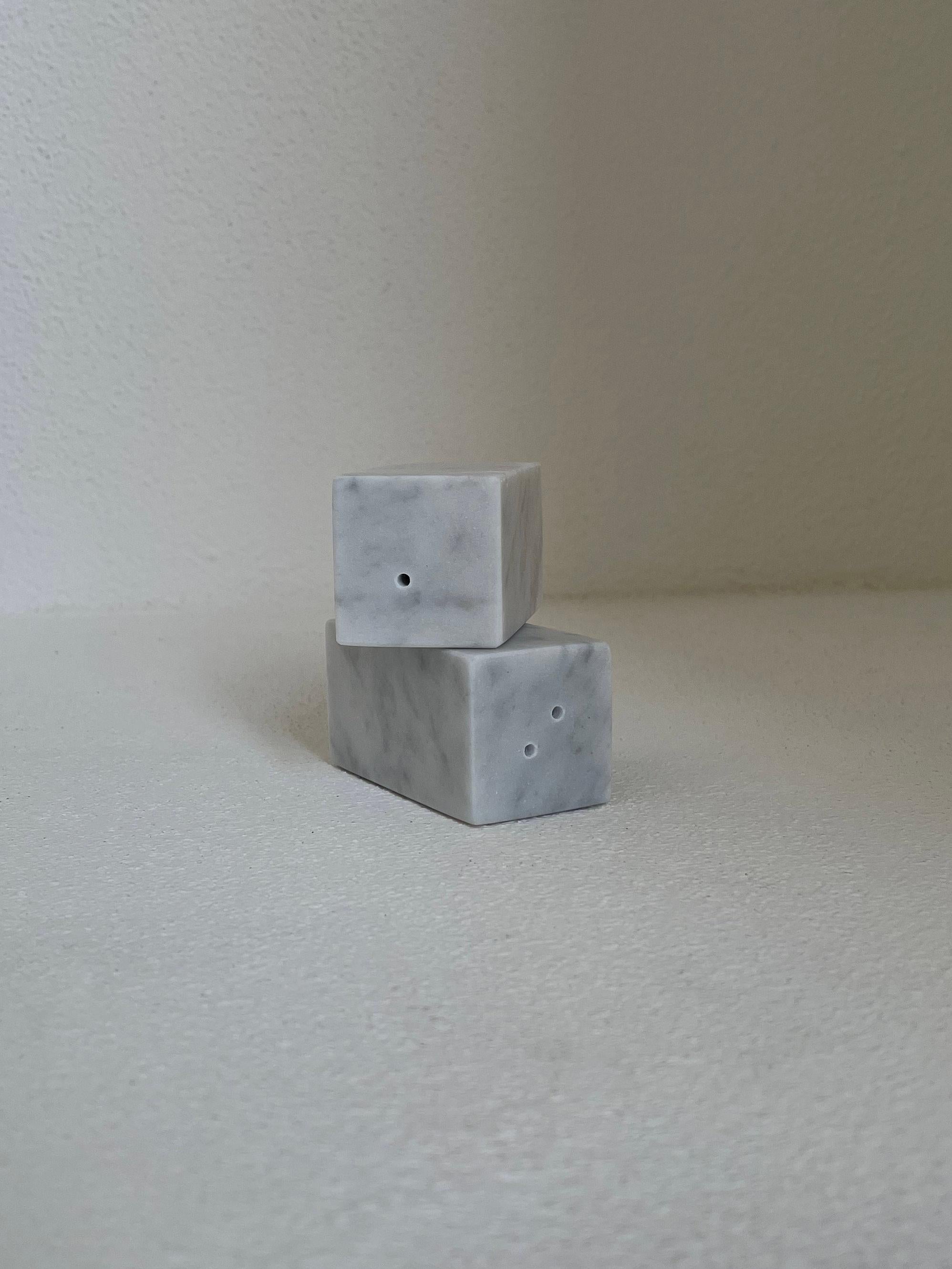 Squared shape salt and pepper set in satin white Carrara marble.
Each piece is in a way unique (since each marble block is different in veins and shades) and handcrafted in Italy. Slight variations in shape, color and size are to be considered a
