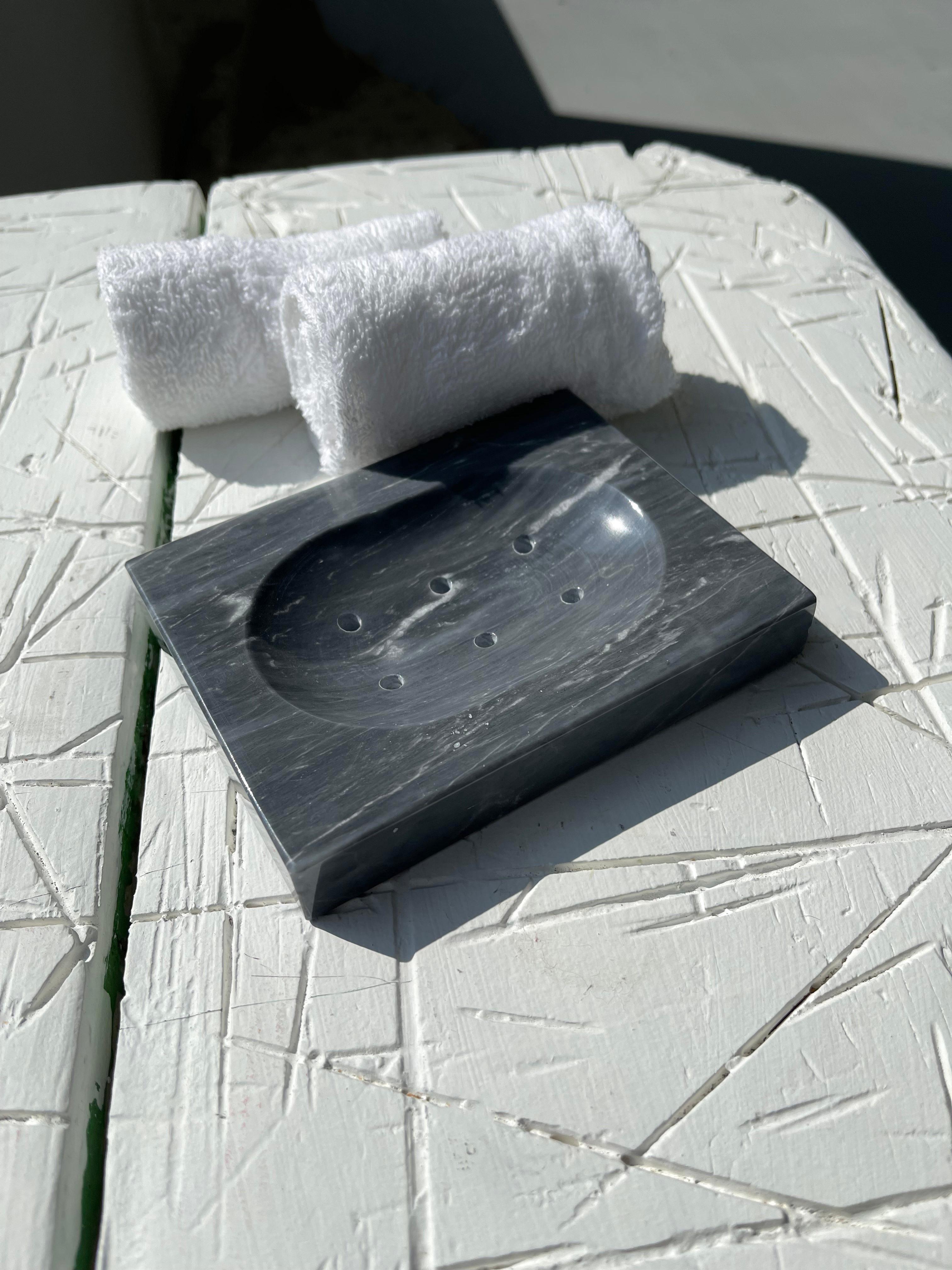 Squared soap dish in grey Bardiglio marble with little holes for water.

Each piece is in a way unique (since each marble block is different in veins and shades) and handcrafted in Italy. Slight variations in shape, color and size are to be