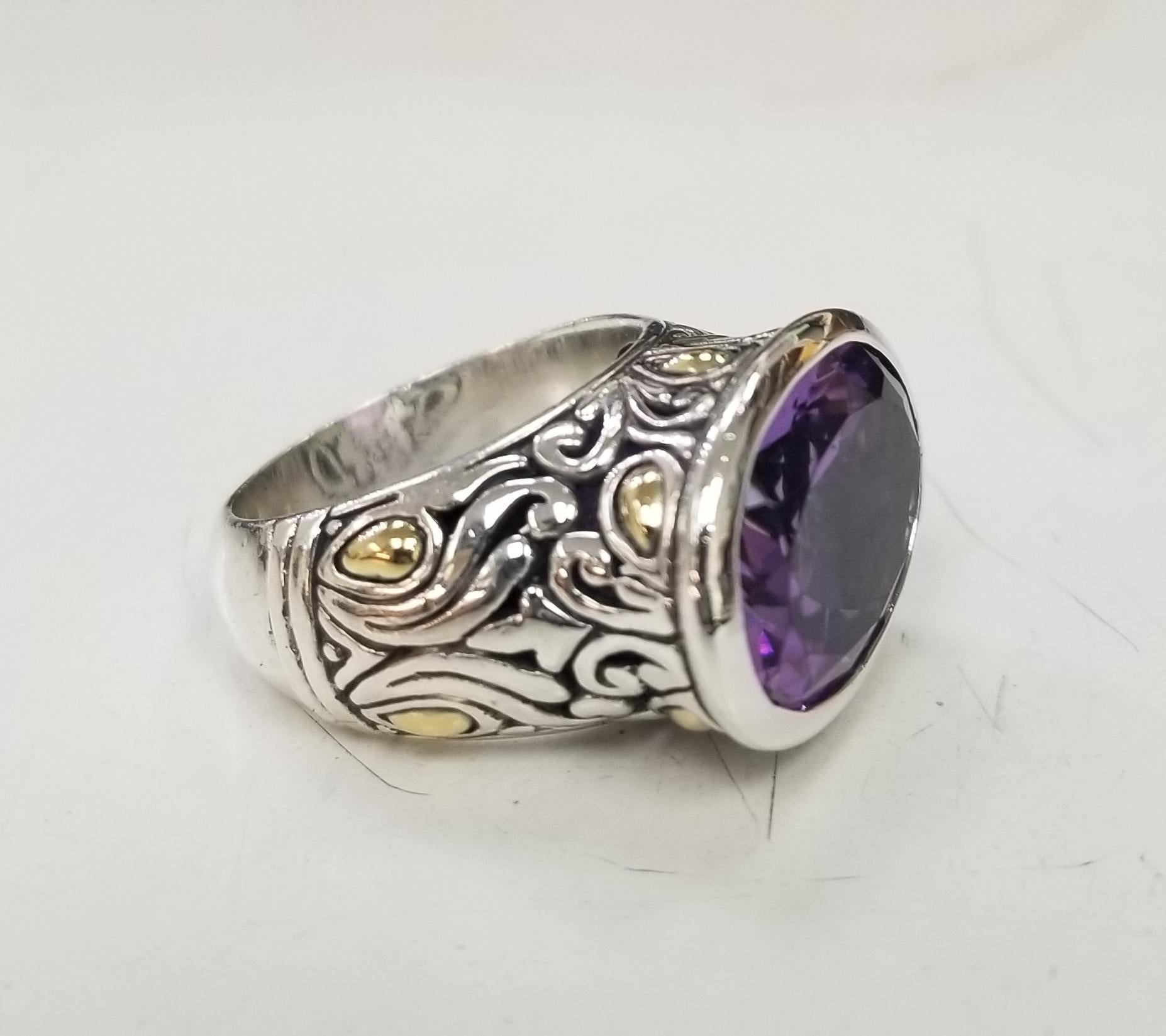 Handmade Sterling Silver and 18k accents, Bezel set Amethyst  Ring, containing 1 oval amethyst of  gem quality weighing approximately 16.00ct.s (17mmx 13mm) ring is a size 7
