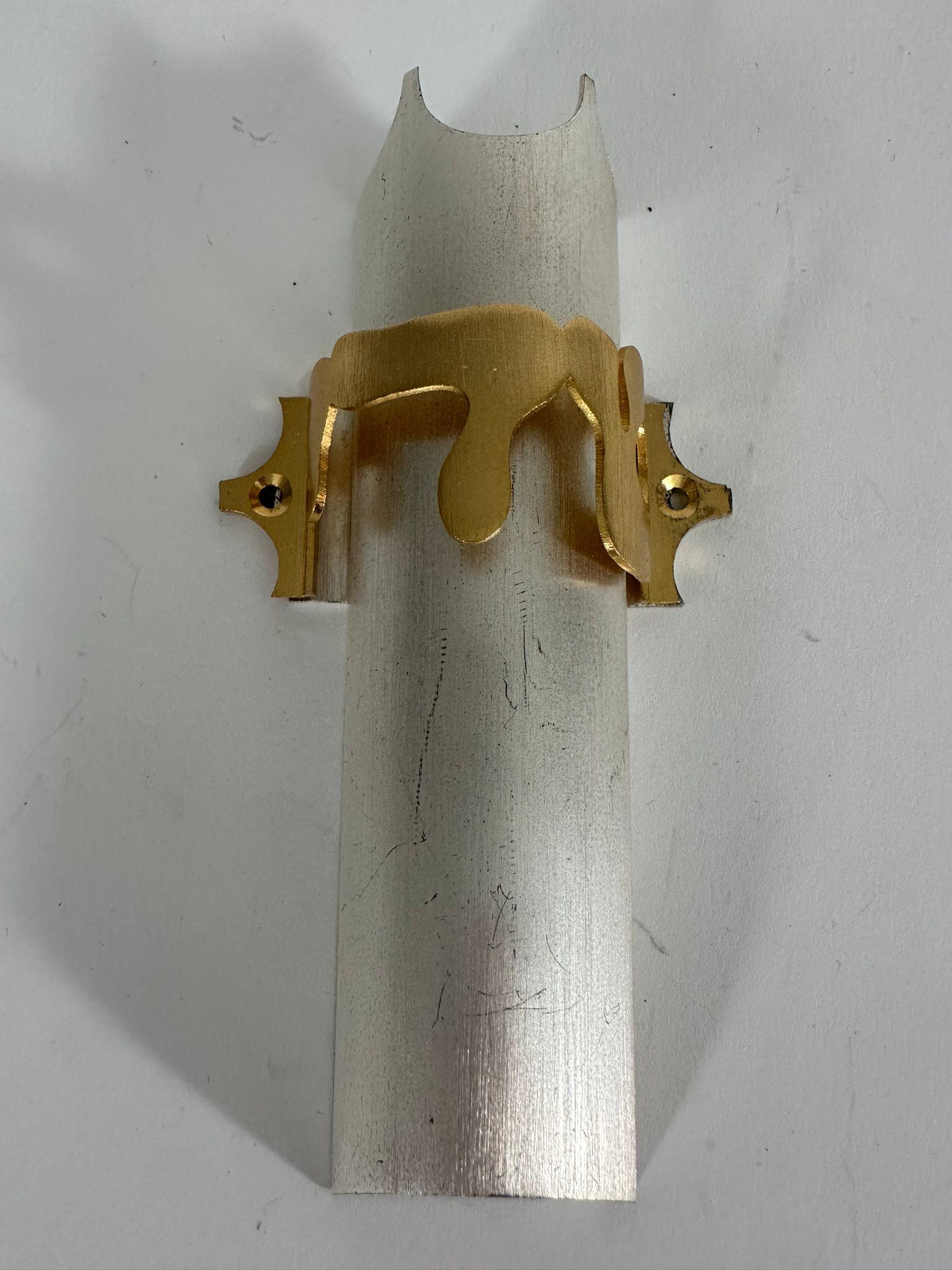 This exquisite handmade Mezuzah case is a unique piece crafted in Jerusalem in 1986 by the renowned Israeli artist Carmel Shabi. Made of sterling silver (hallmarked 925), the Mezuzah features an elegant brushed silver body adorned with a gold-plated