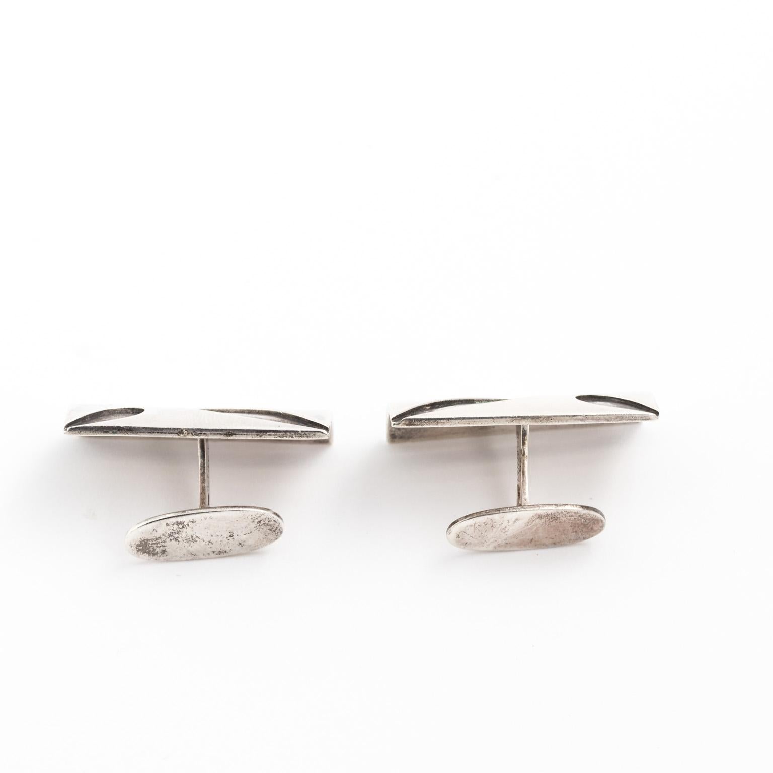 Circa 1950s handmade Sterling Silver cuff links from Denmark with cut abstract designs on the rectangular front. 