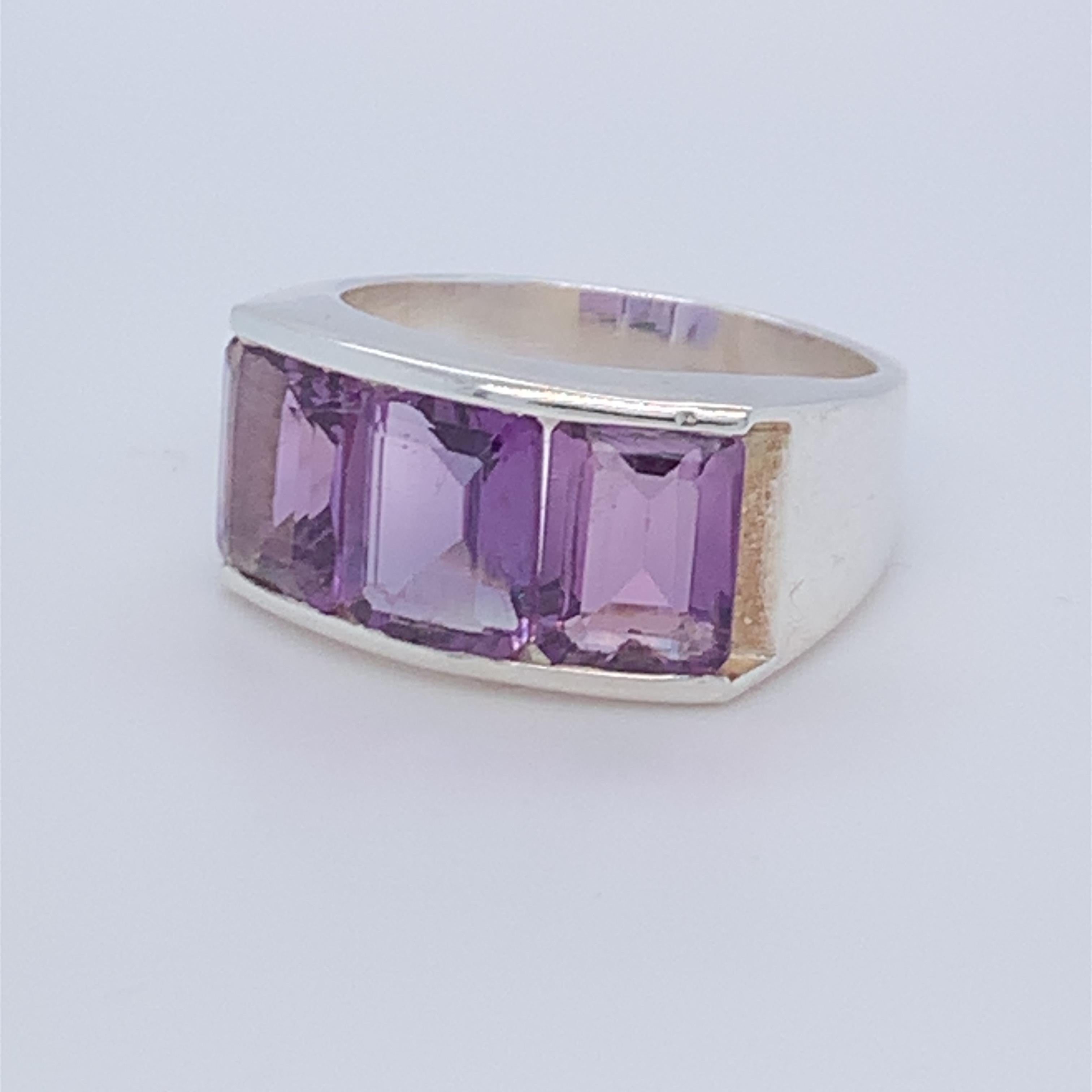 This beautiful half band ring boasts three emerald cut amethyst. Birthstone of the month of February. it is simple, plain and suitable for day wear. Set in sterling silver and hand made by master craftsman.

Amethyst: 6.00ct (approx)
Size: 9