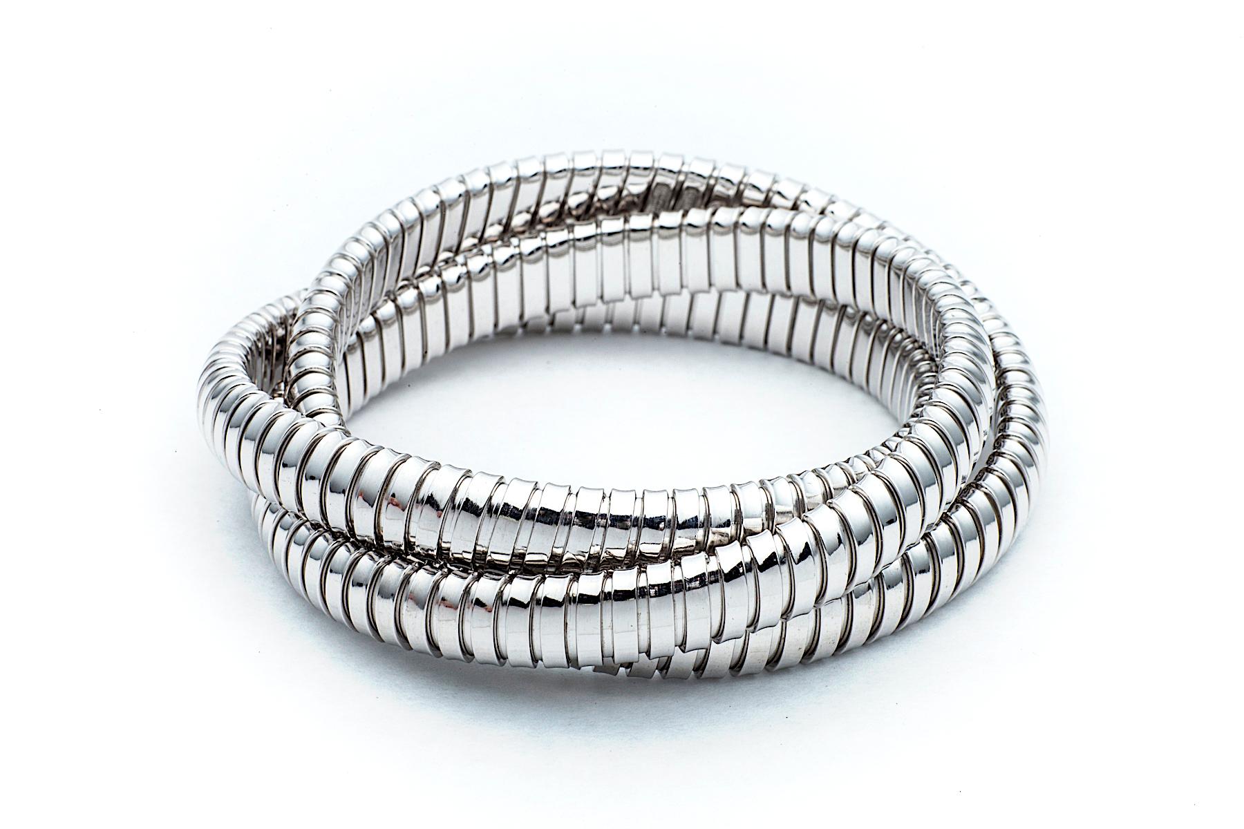 With a timeless but modern style, this chic intertwined 9mm three strand tubogas rolling bangle bracelet was originally inspired by the flexible automotive gas tubing of the 1920’s.  Translated into sterling silver and easily stacked with other