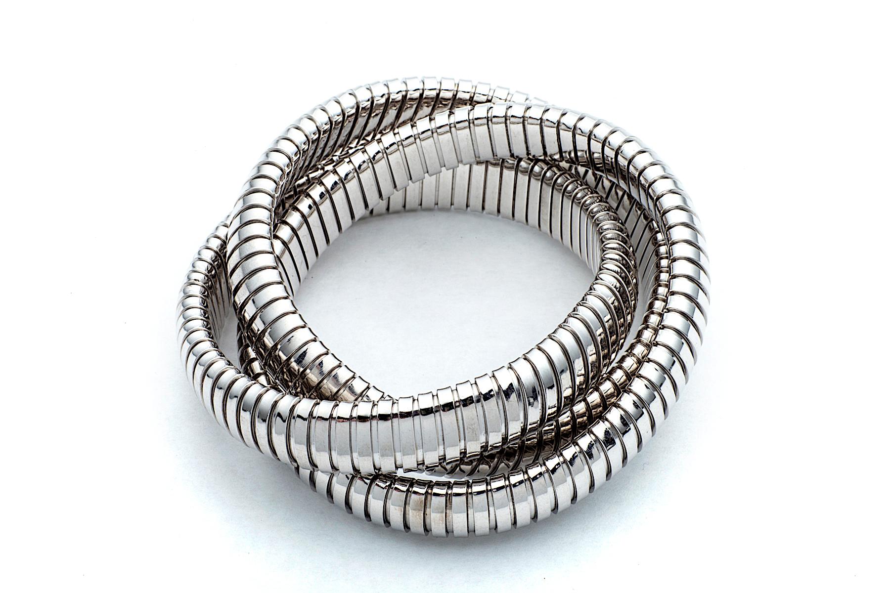 With a timeless but modern style, this chic intertwined 12 mm three strand tubogas rolling bangle bracelet was originally inspired by the flexible automotive gas tubing of the 1920’s.  Translated into sterling silver and easily stacked with other