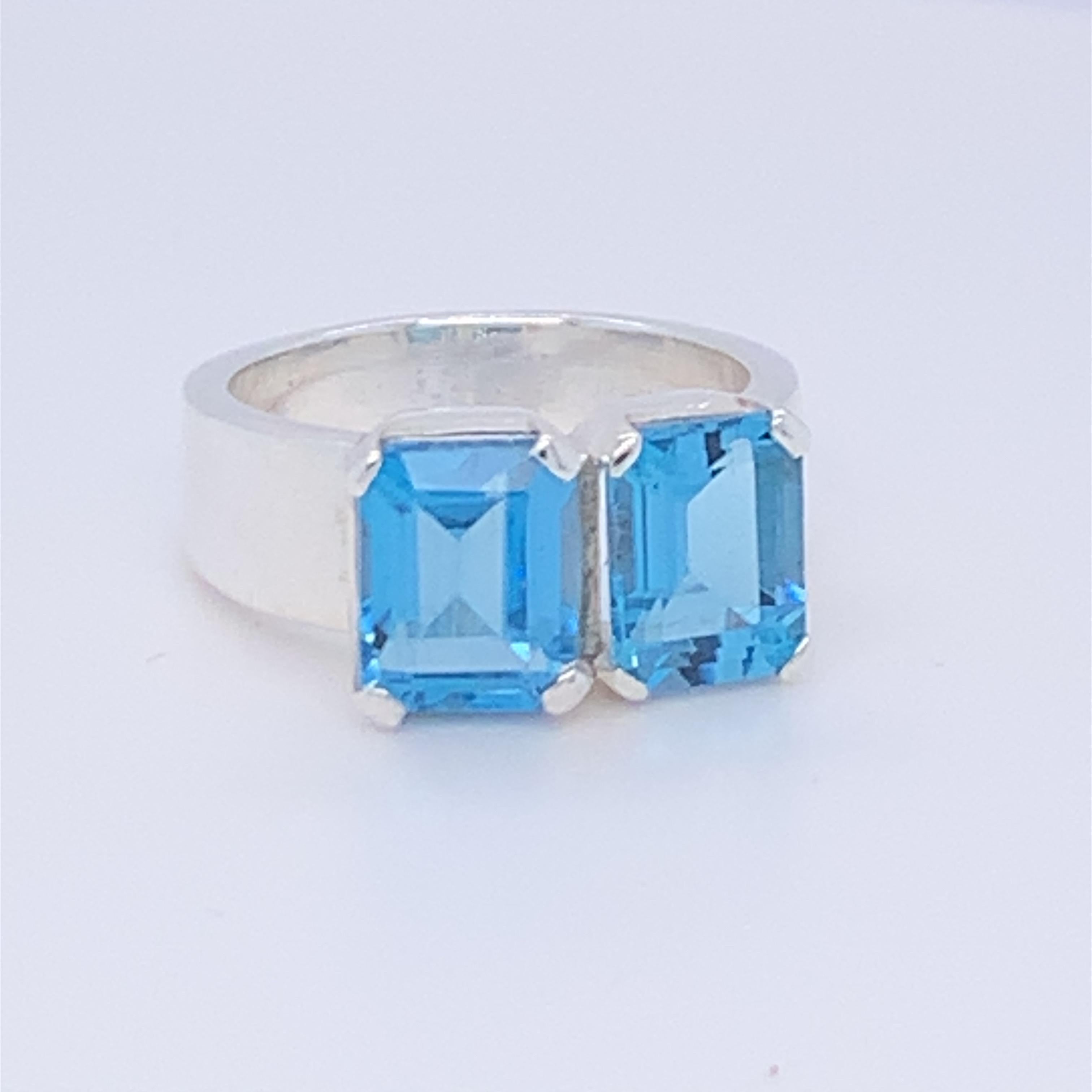 This beautiful two stone ring has two octagonal blue topaz. It is simple yet chic and perfect for day wear. Set in sterling silver and hand made by master craftsman.

Total weight of blue topaz: 6.00ct (approximate)
Size: 7