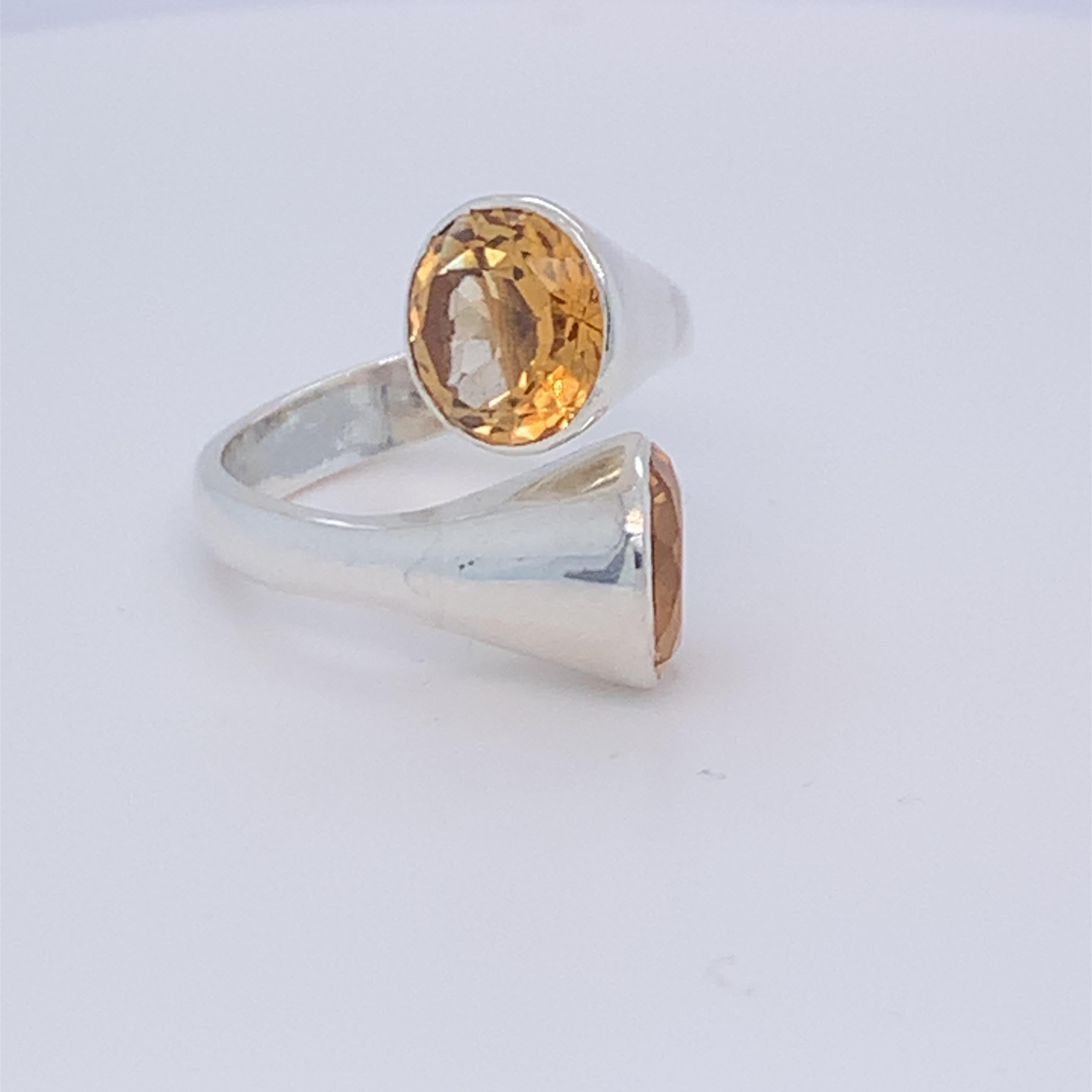 This beautiful tube design two stone ring boasts round citrine. Birthstone of the month of November. Its unique and chic design is suitable for day wear. Set in sterling silver and hand made by master craftsman.

Total weight of stone: 5.00ct