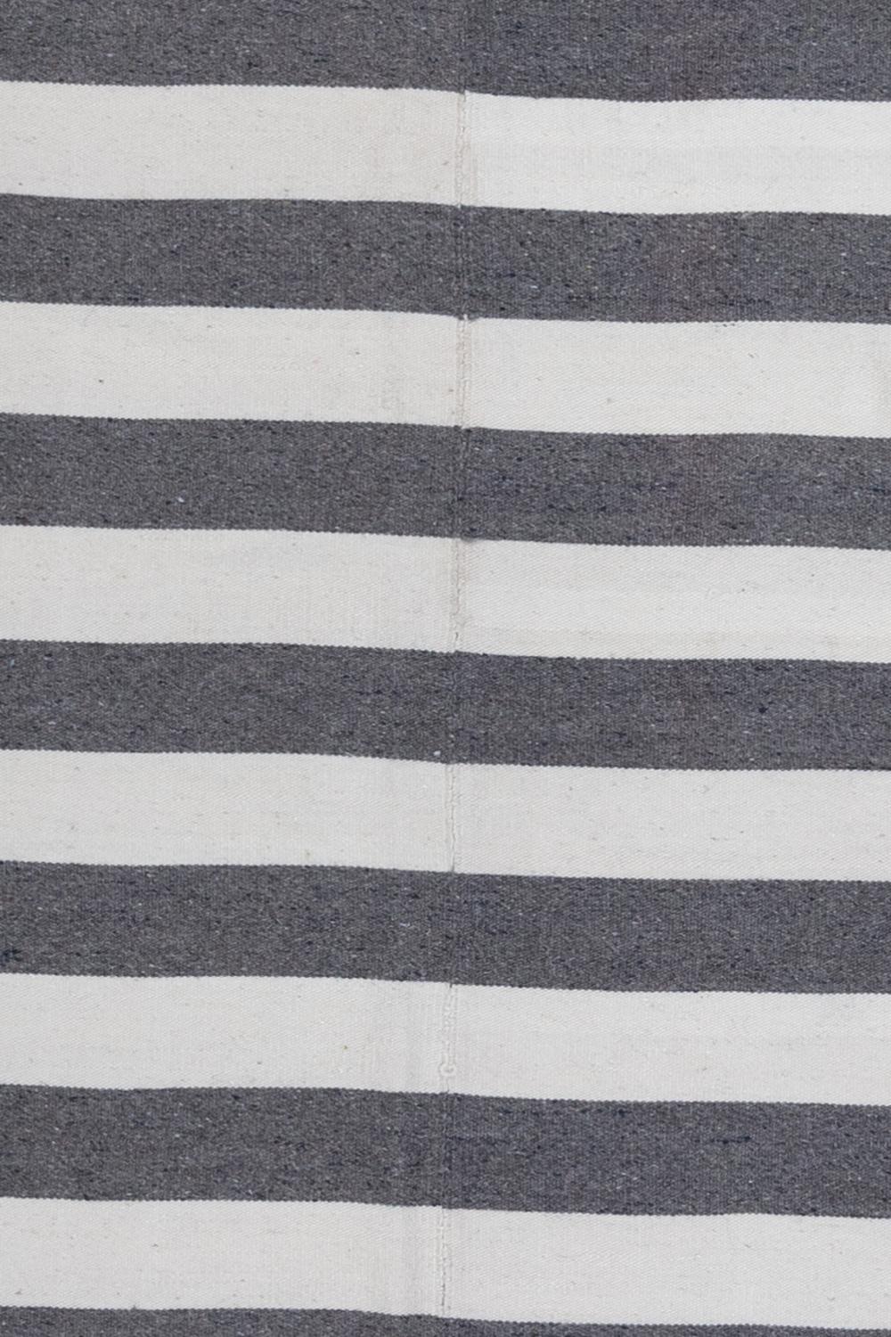 Age: New

Pile: flatweave

Wear Notes: 0

Material: wool

Flatwoven soft wool kilim in alternating gray and white stripes. Made by hand in Turkey.

Wear Guide:
Vintage and antique rugs are by nature, pre-loved and may show evidence of